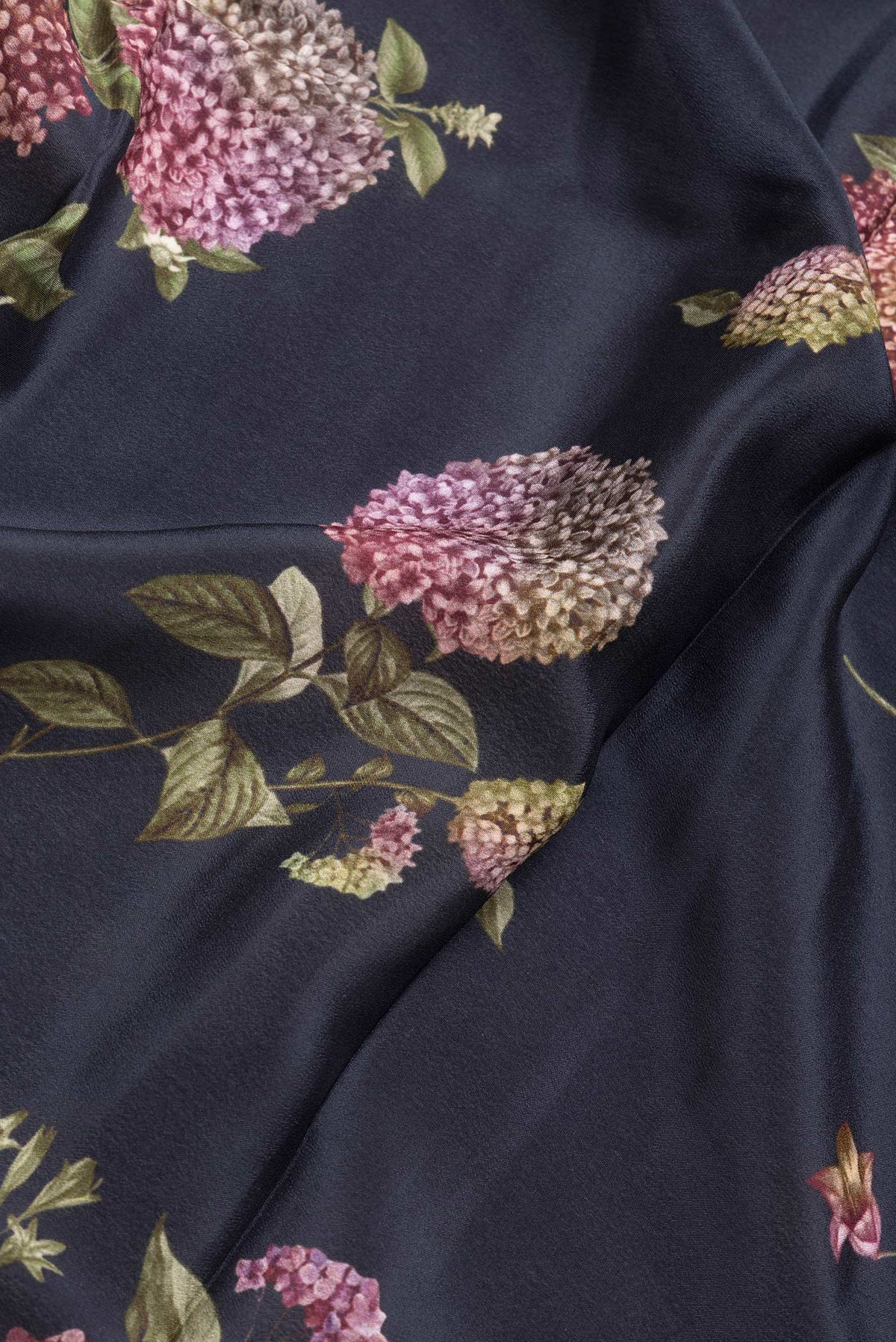 Close up of Black Dual Tone Mysore Crepe Saree with Printed design on the body and Without Border.  displaying folds