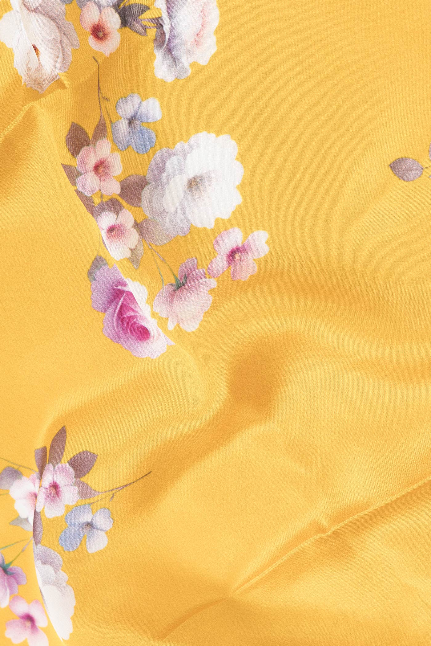 Close up of Yellow Dual Tone Mysore Crepe Saree with Printed design on the body and Without Border.  displaying folds