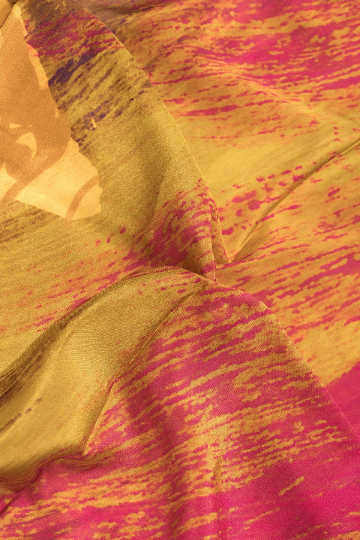Close up of Burgundy Dual Tone Mysore Crepe Saree with Printed design on the body and Plain Border.  displaying folds