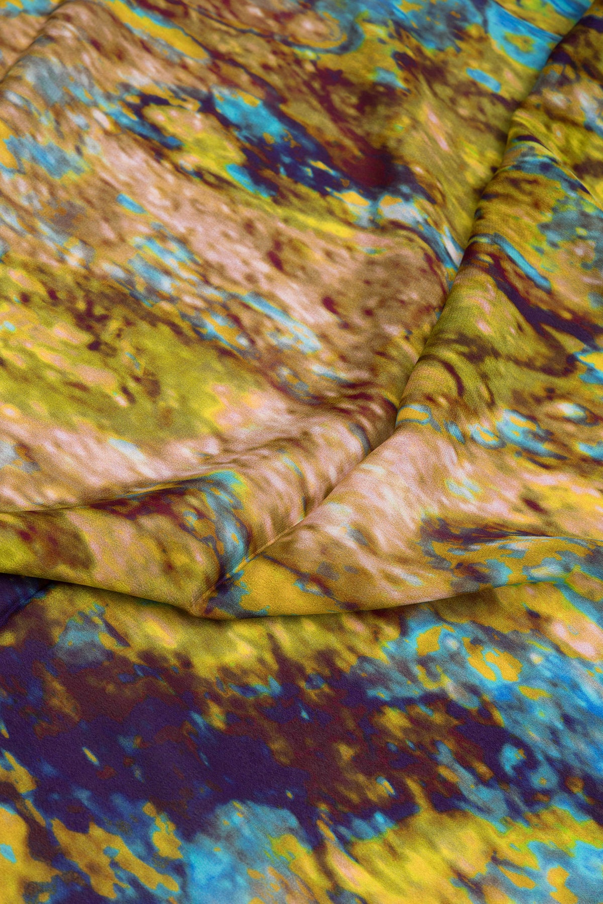 Close up of Mehandi Green Crepe Saree with Printed design on the body and Plain Border.  displaying folds