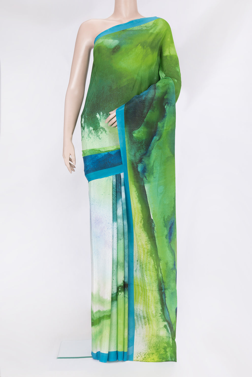 Green Crepe Saree with Printed design on the body and Plain Border.  displayed on a mannequin