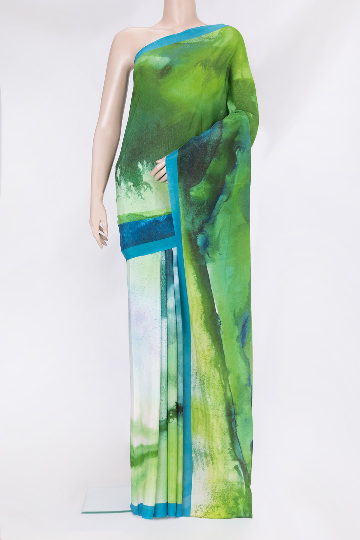 Green Crepe Saree with Printed design on the body and Plain Border.  displayed on a mannequin