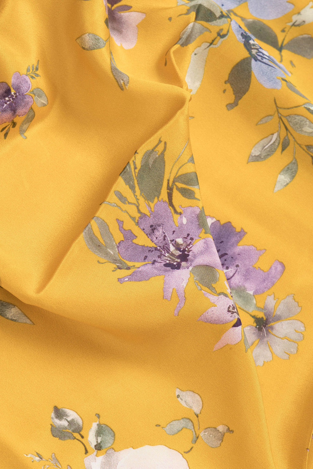 Close up of Yellow Dual Tone Mysore Crepe Saree with Printed design on the body and Without Border.  displaying folds
