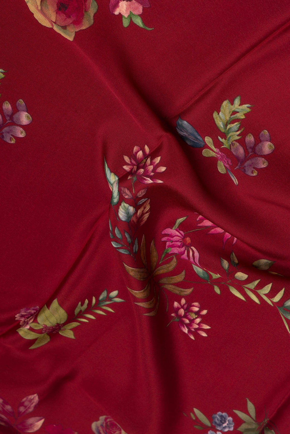 Close up of Maroon Crepe Saree with Floral Print on the body and Without Border.  displaying folds
