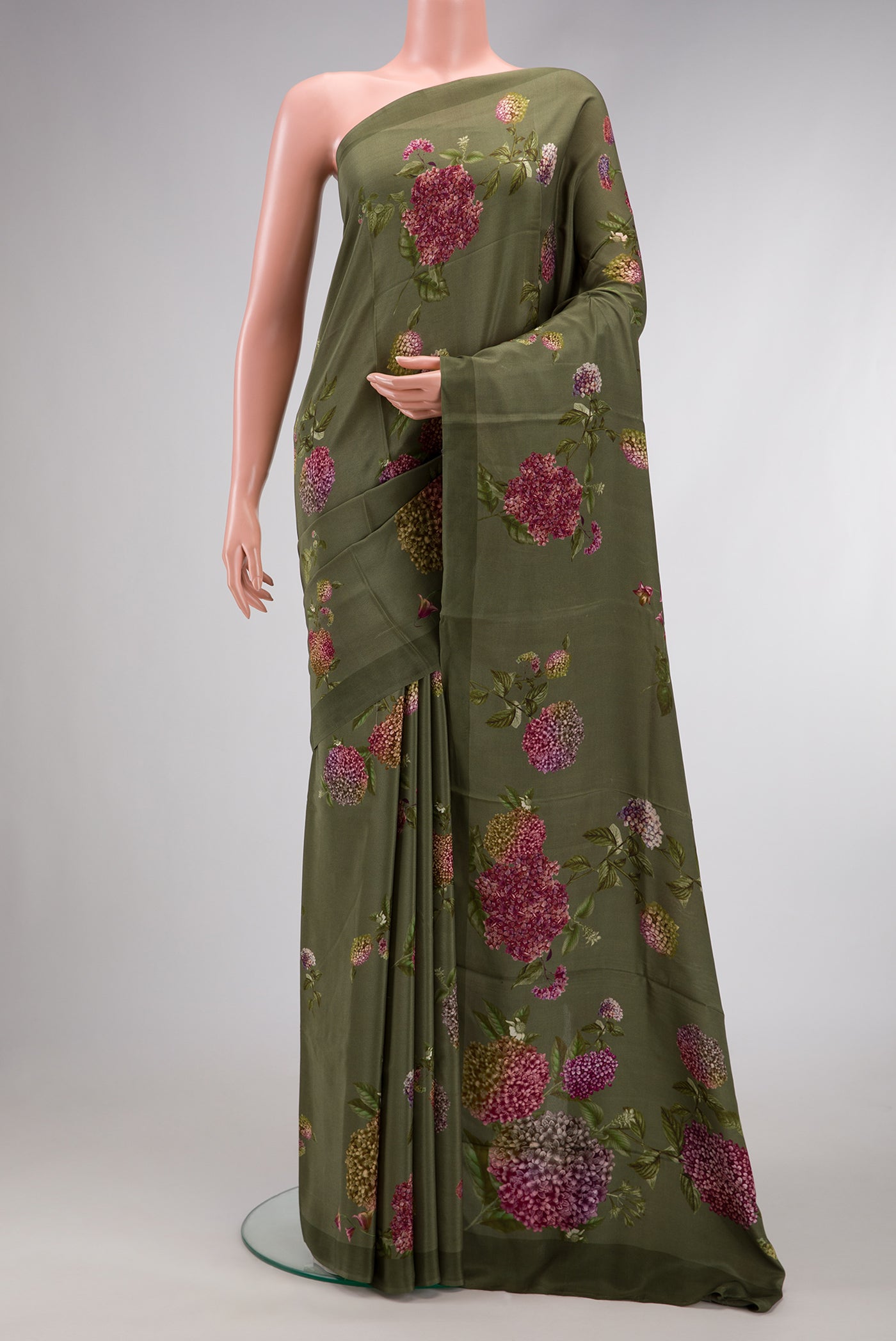Green Dual Tone Mysore Crepe Saree with Printed design on the body and Plain Border.  displayed on a mannequin