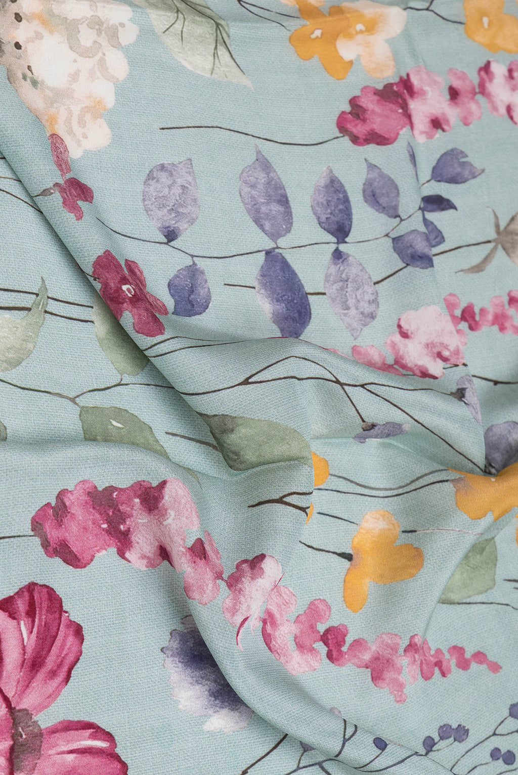 Close up of Grey Crepe Saree with Floral Print on the body and Plain Border.  displaying folds
