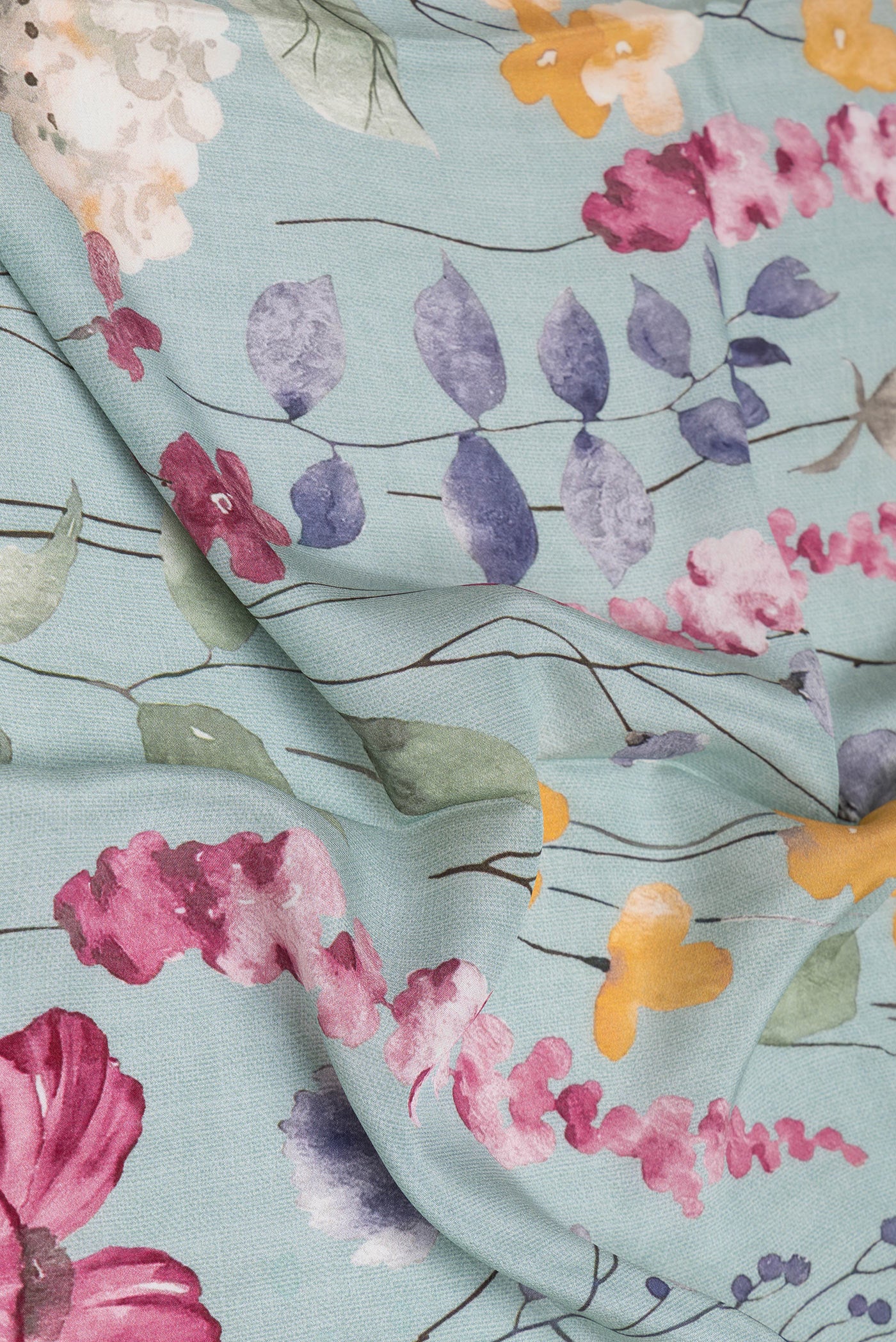 Close up of Grey Crepe Saree with Floral Print on the body and Plain Border.  displaying folds