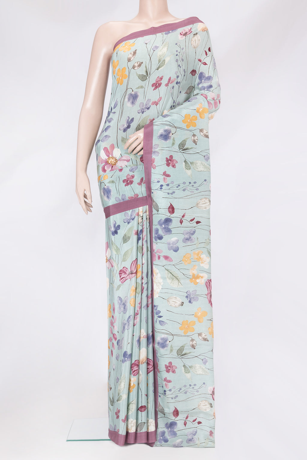 Grey Crepe Saree with Floral Print on the body and Plain Border.  displayed on a mannequin