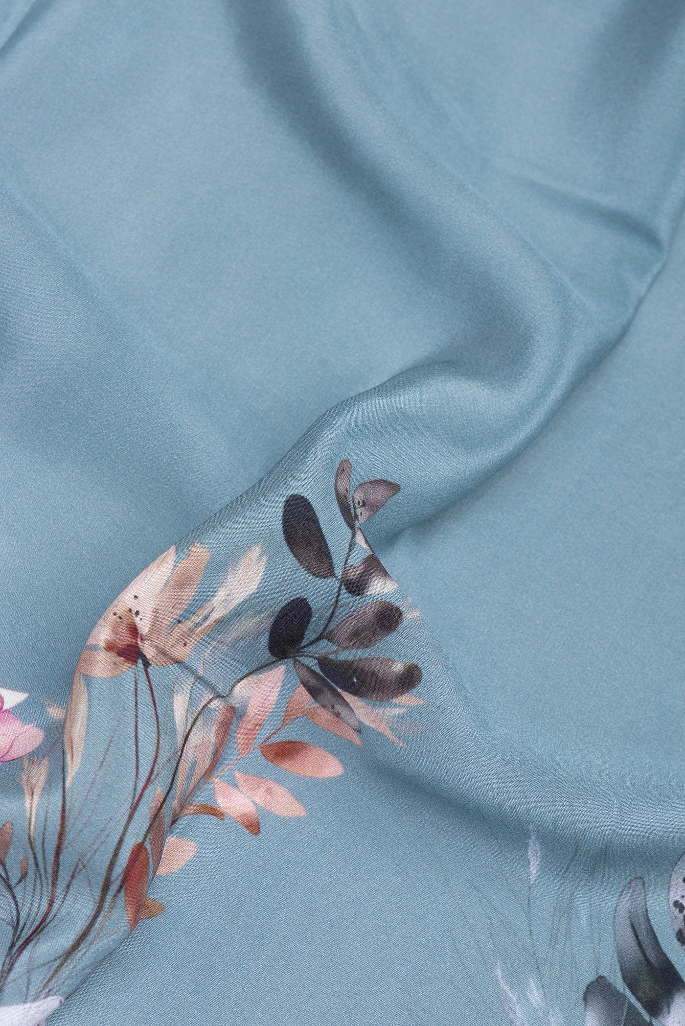 Close up of Grey Crepe Saree with Printed design on the body and Plain Border.  displaying folds