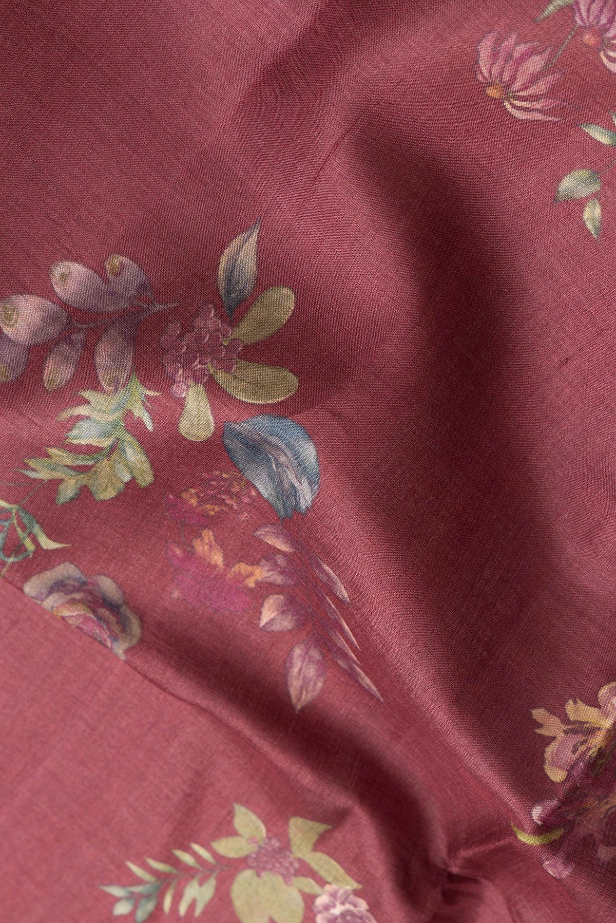 Close up of Maroon Dual Tone Tussar Silk Saree with Printed design on the body and Zari Border.  displaying folds