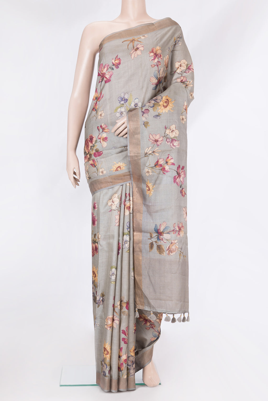 Grey Tussar Silk Saree with Floral Print on the body and Zari Border.  displayed on a mannequin