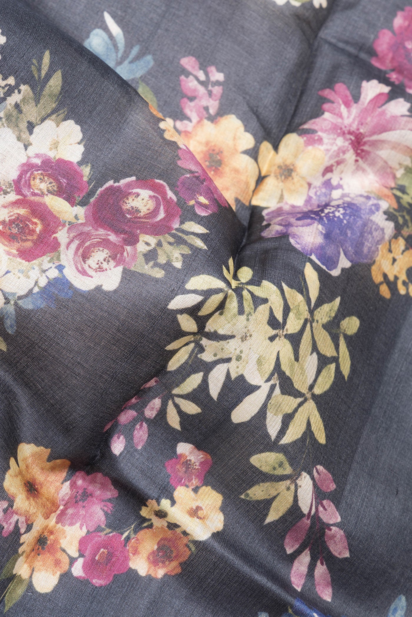 Close up of Black Tussar Silk Saree with Printed design on the body and Zari Border.  displaying folds