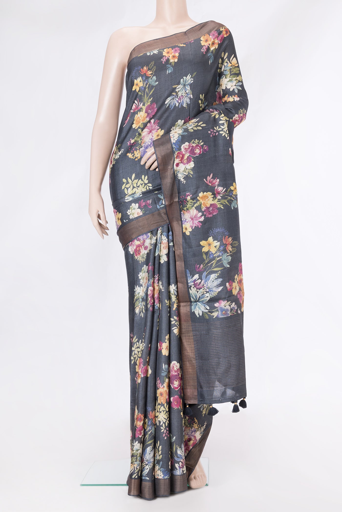 Black Tussar Silk Saree with Printed design on the body and Zari Border.  displayed on a mannequin