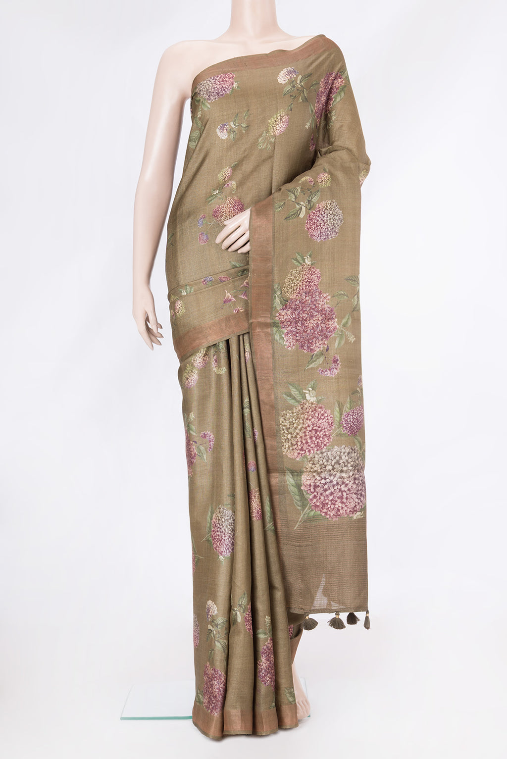 Brown Tussar Silk Saree with Printed design on the body and Zari Border.  displayed on a mannequin