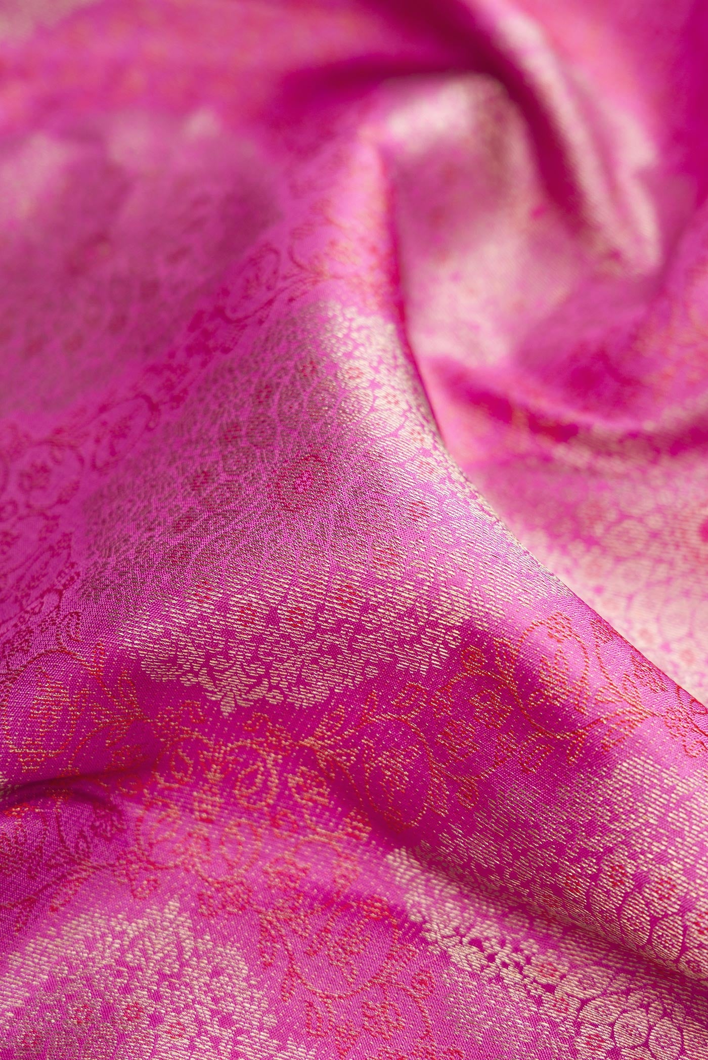 Close up of Pink Dual Tone Kanjivaram Silk Saree with Zari Brocade on the body and Zari Border.  displaying folds