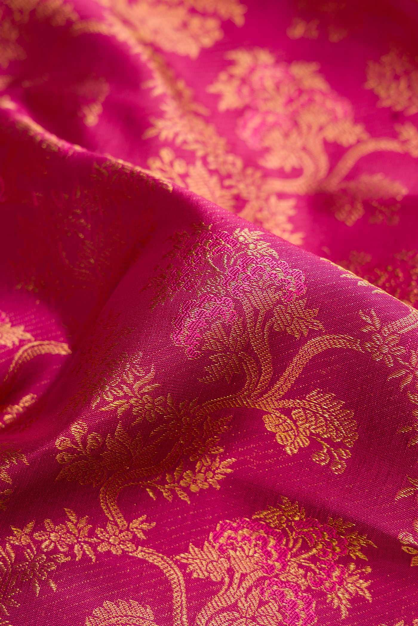 Close up of Dark Mauve Dual Tone Kanjivaram Silk Saree with Zari Brocade on the body and Zari Border.  displaying folds