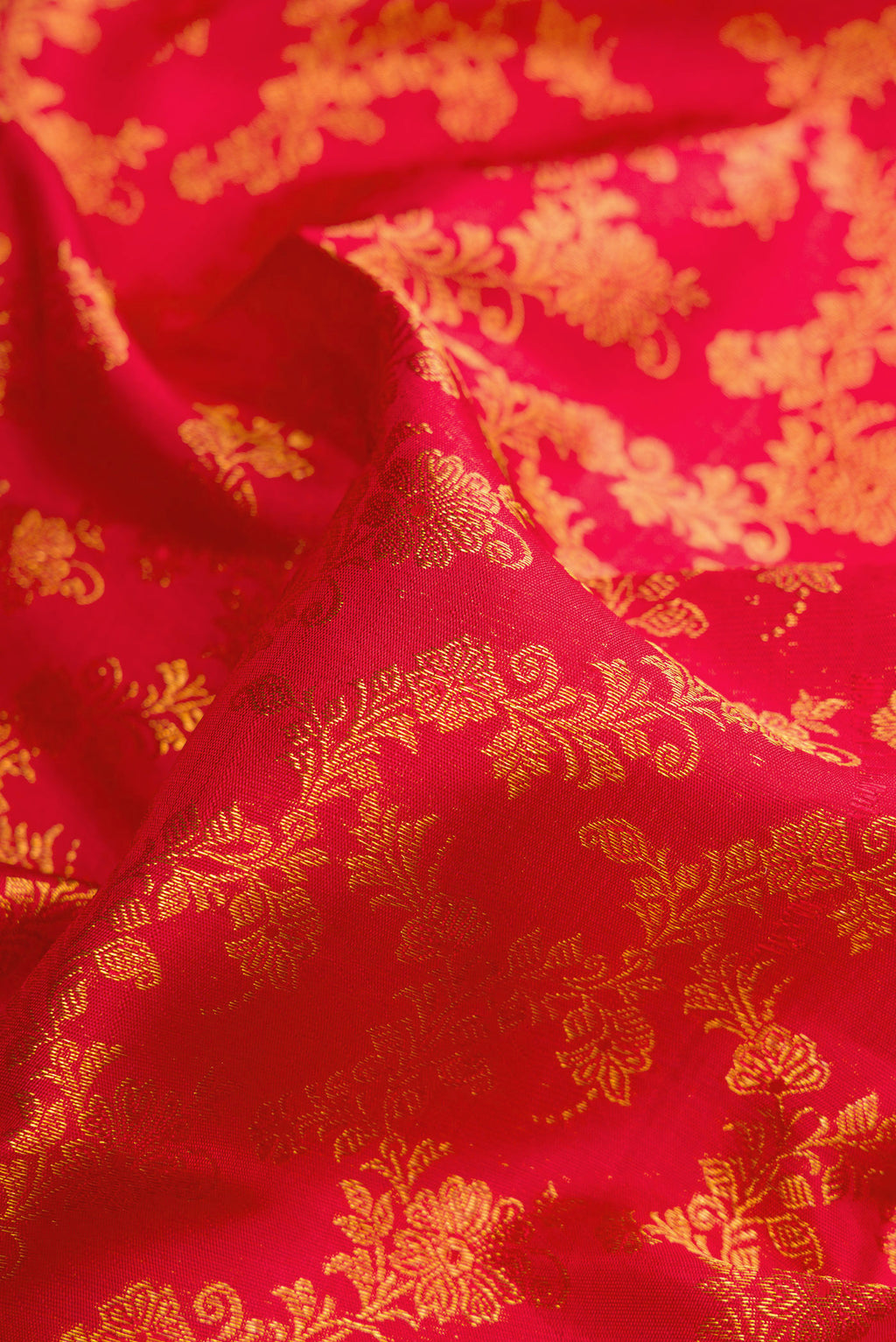 Close up of Red Dual Tone Kanjivaram Silk Saree with Zari Brocade on the body and Zari Border.  displaying folds