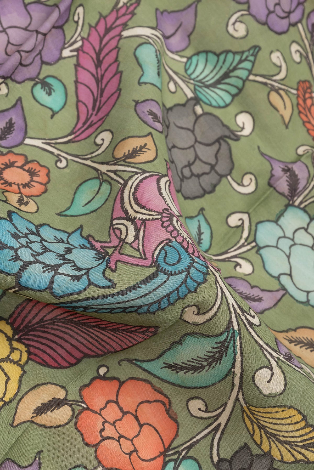 Close up of Mehandi Green Dual Tone Tussar Silk Saree with Printed design on the body and Zari Border.  displaying folds