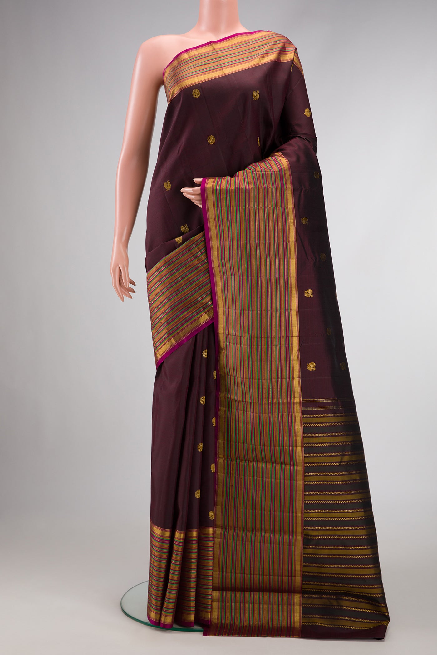 Burgundy Dual Tone Kanjivaram Silk Saree with Zari Butta on the body and Zari Border.  displayed on a mannequin