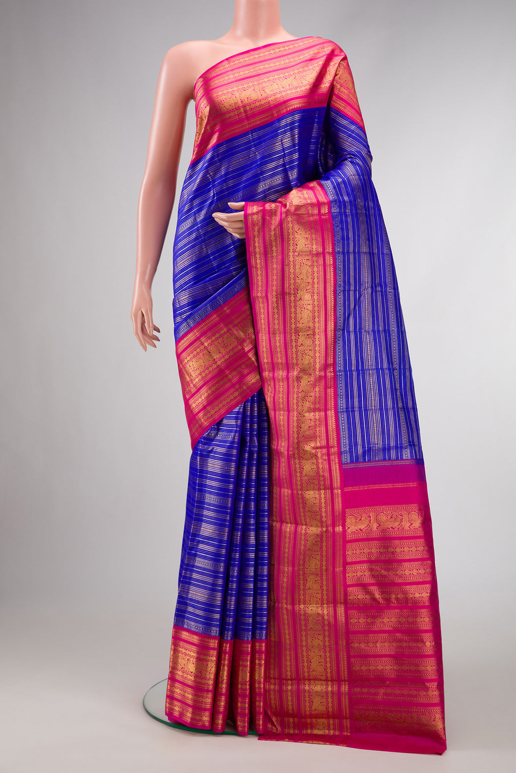 Pure Silk Pure Zari Royal Blue Dual Tone Kanchipuram Saree with Stripes on the body and Zari Border.  displayed on a mannequin