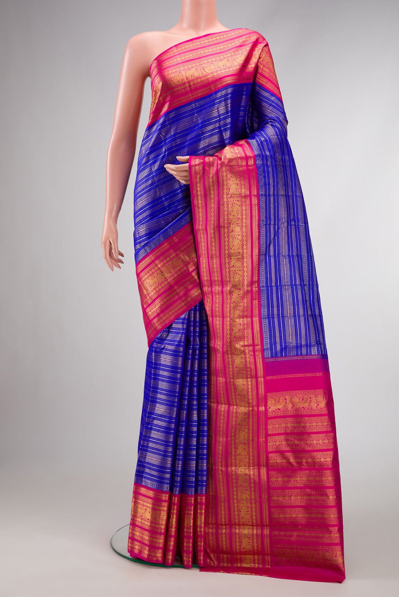 Pure Silk Pure Zari Royal Blue Dual Tone Kanchipuram Saree with Stripes on the body and Zari Border.  displayed on a mannequin
