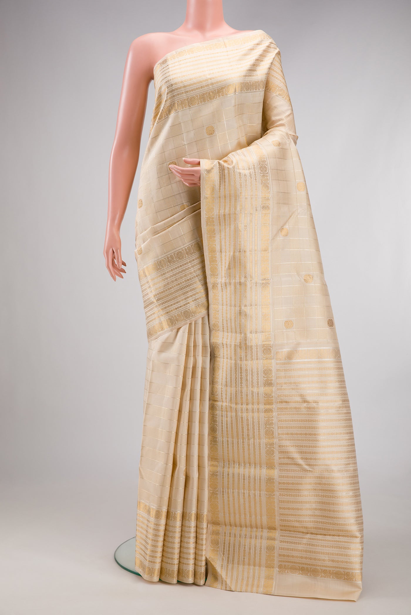 Beige Dual Tone Kanchipuram Silk Saree with Checked design on the body and Fancy Border.  displayed on a mannequin