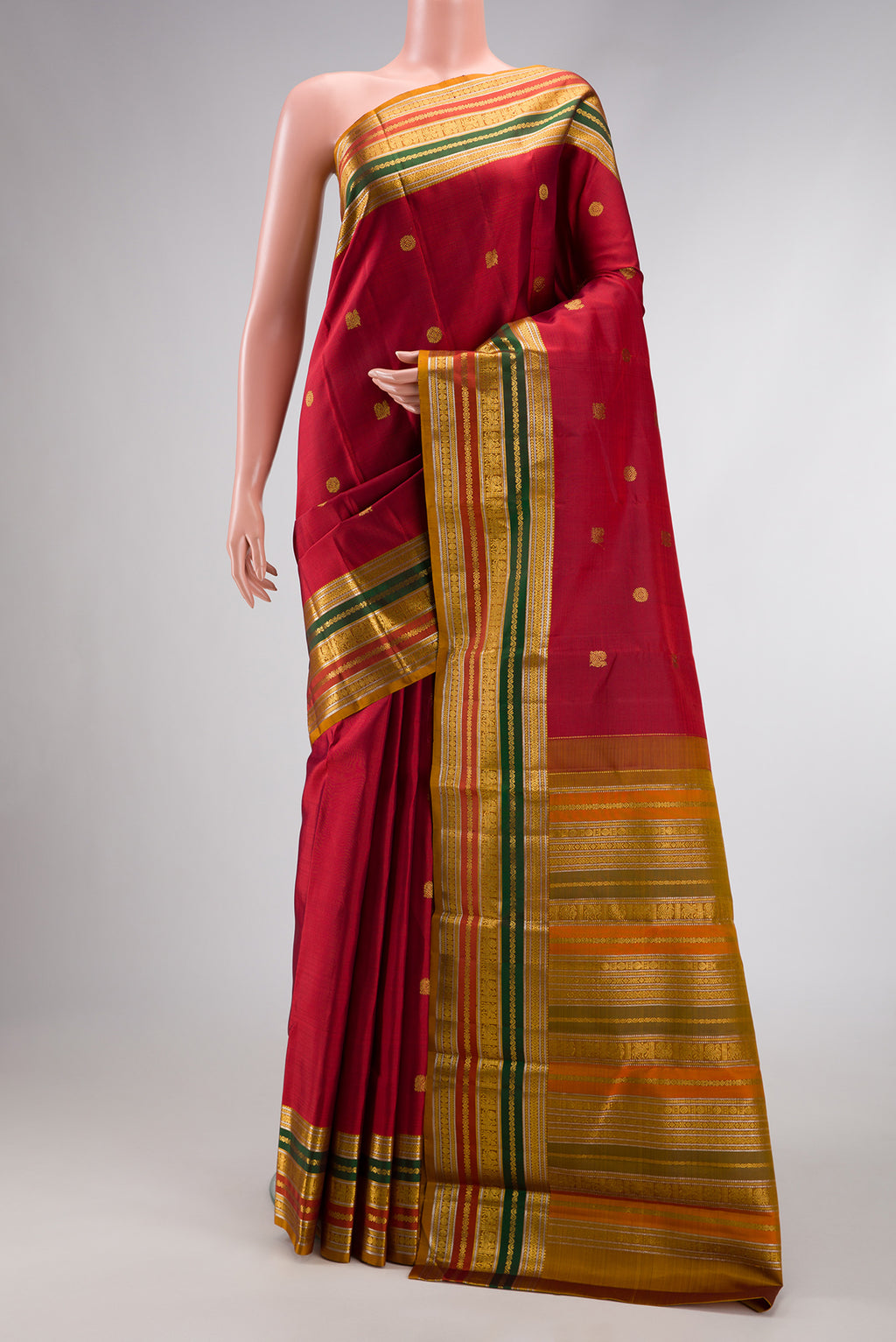 Red Dual Tone Kanjivaram Silk Saree with Zari Butta on the body and Zari Border.  displayed on a mannequin