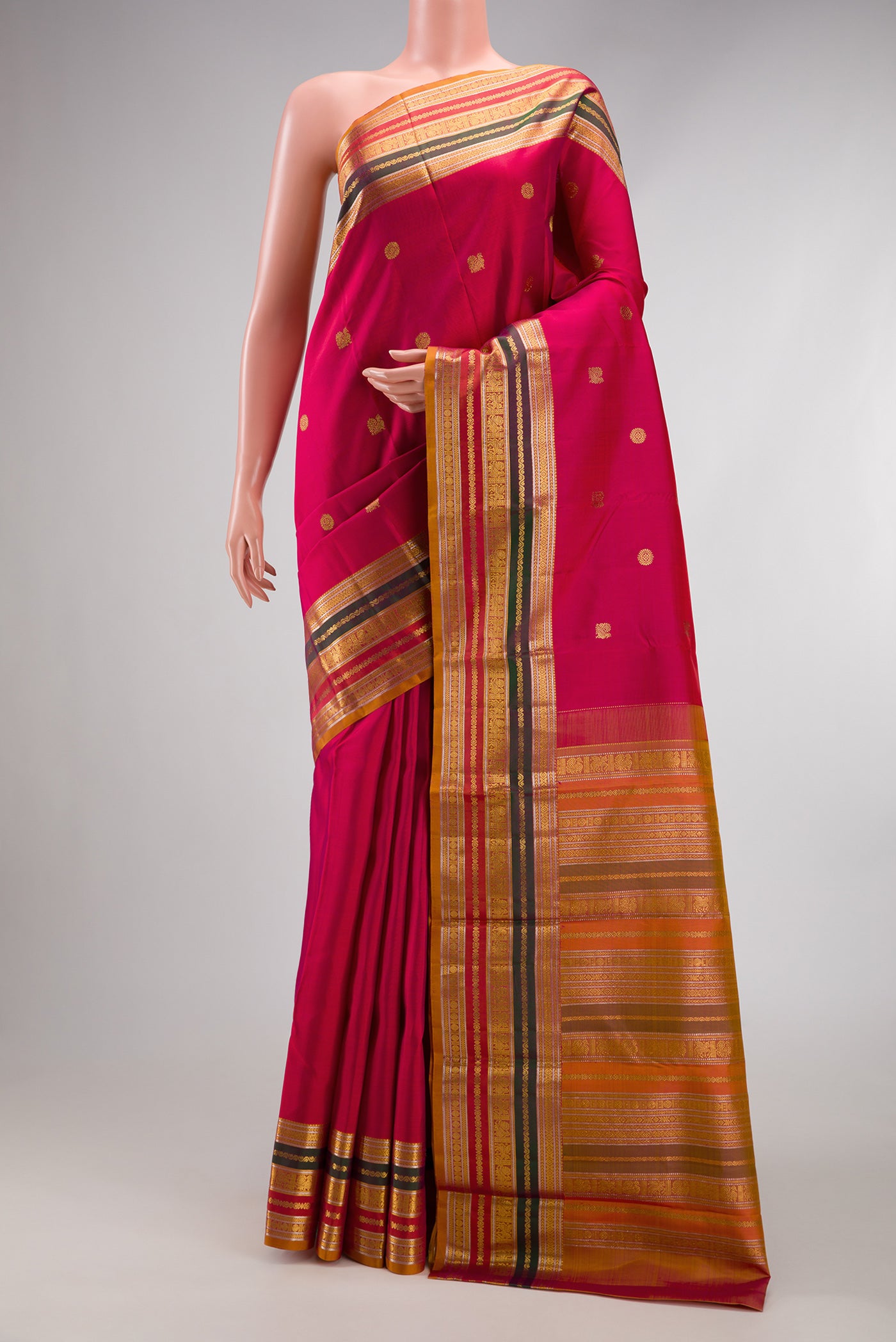 Dark Pink Kanjivaram Silk Saree with Zari Butta on the body and Zari Border.  displayed on a mannequin