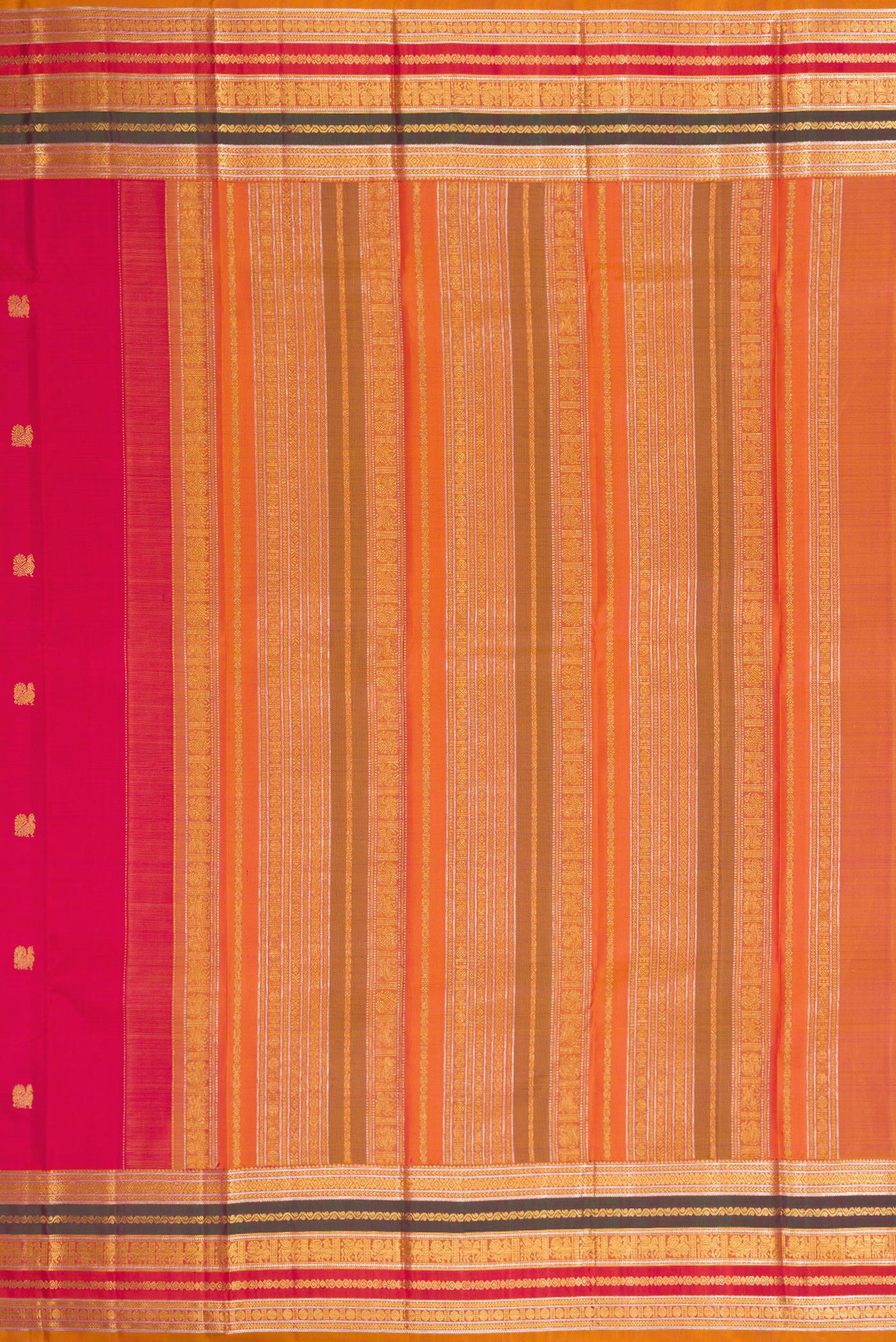 Close up image of the pallu of Dark Pink Kanjivaram Silk Saree with Zari Butta on the body and Zari Border. 