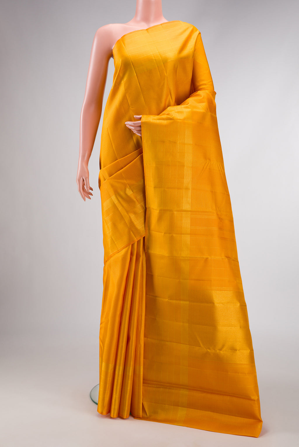 Yellow Dual Tone Kanchipuram Silk Saree with Checked design on the body and Zari Border.  displayed on a mannequin