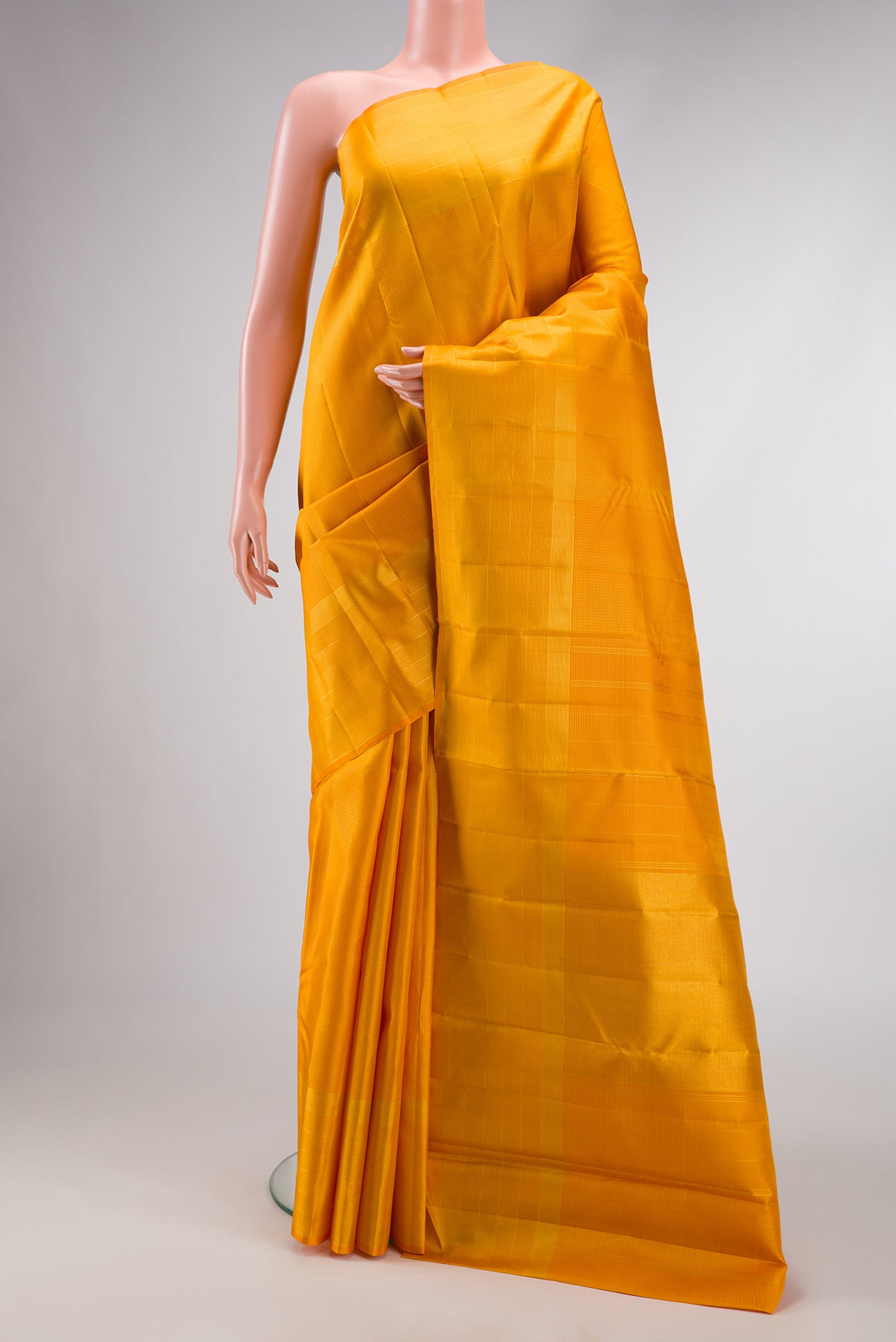 Yellow Dual Tone Kanchipuram Silk Saree with Checked design on the body and Zari Border.  displayed on a mannequin