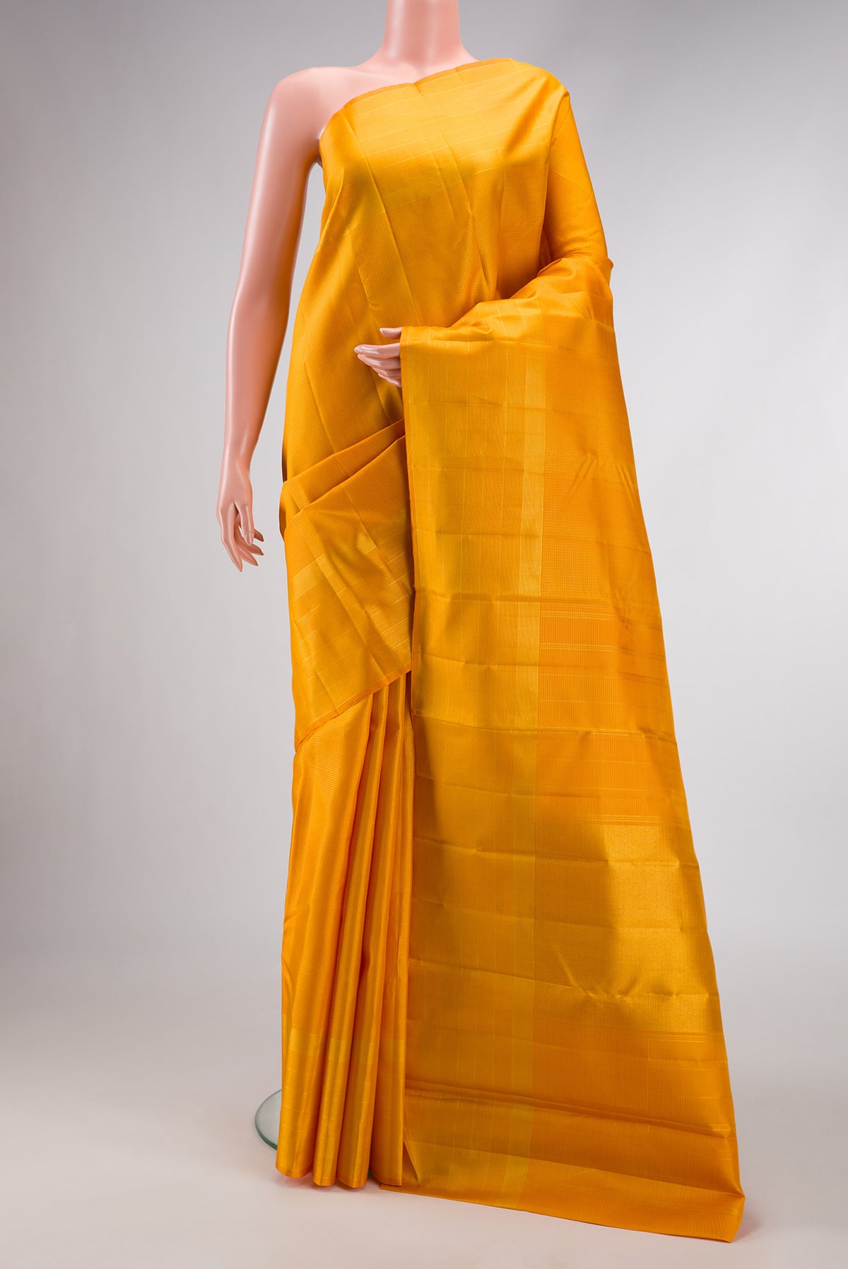Yellow Dual Tone Kanchipuram Silk Saree with Checked design on the body and Zari Border.  displayed on a mannequin