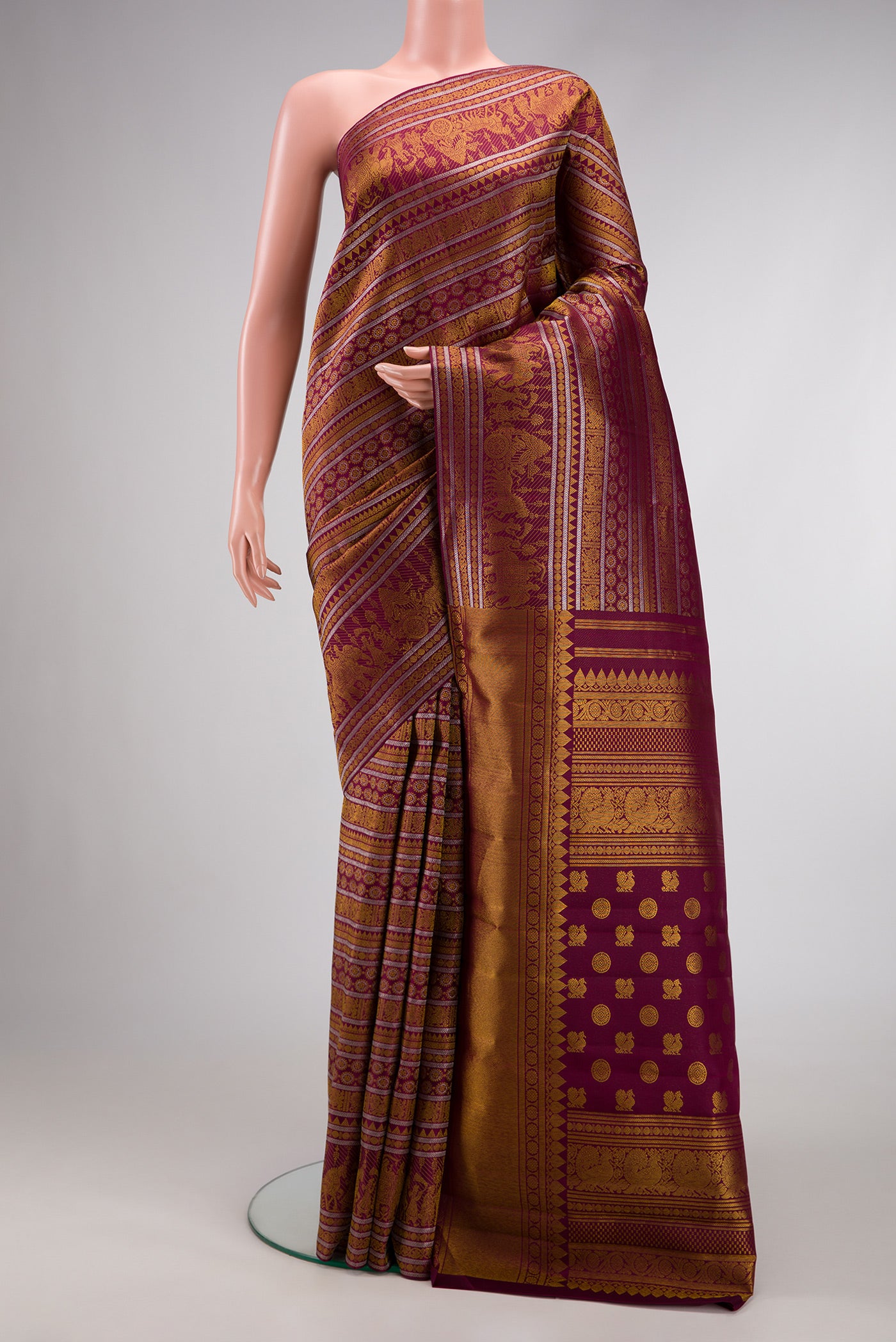 Burgundy Dual Tone Kanchipuram Silk Saree with Zari Brocade on the body and Zari Border.  displayed on a mannequin