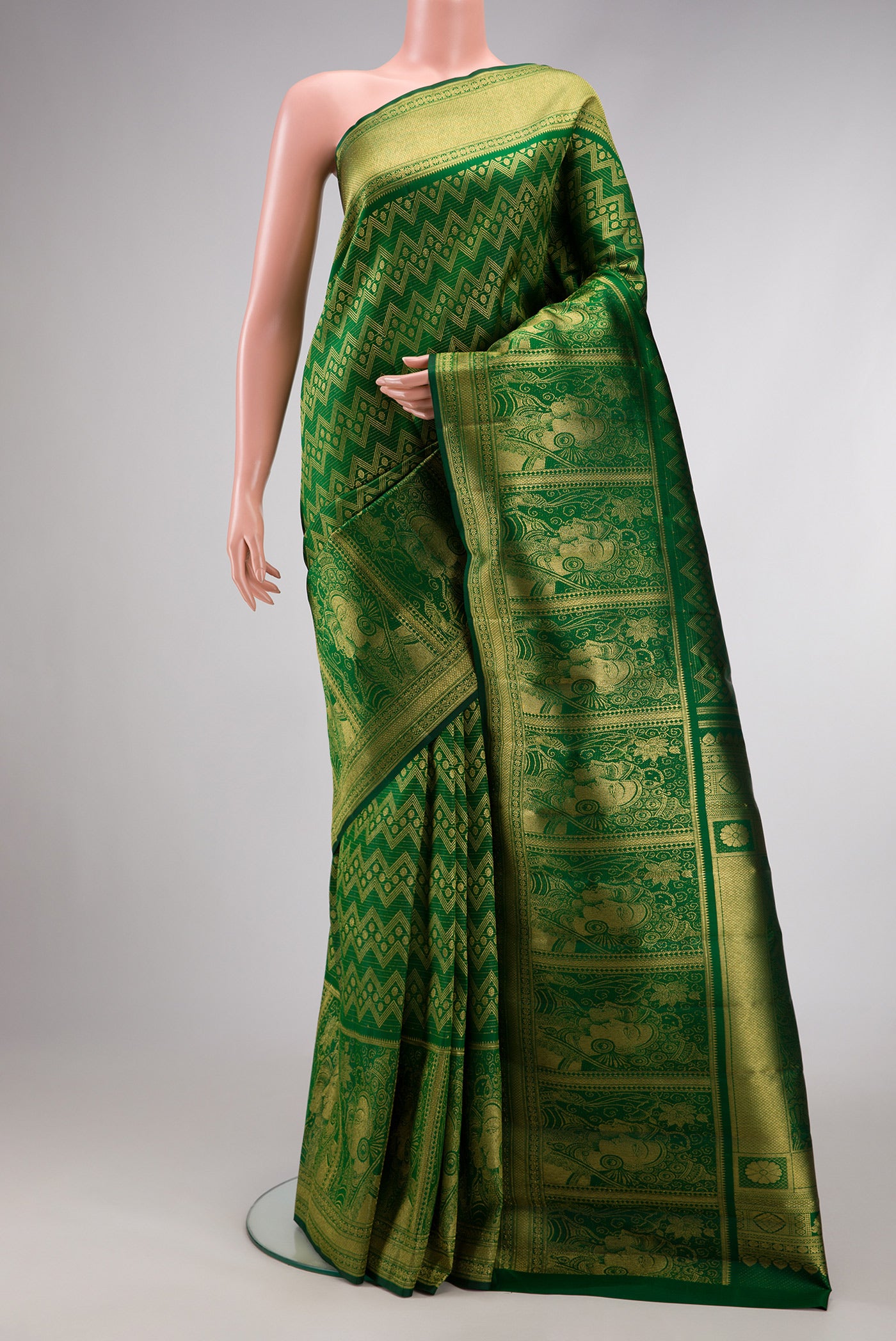 Green Dual Tone Kanchipuram Silk Saree with Zari Brocade on the body and Fancy Border.  displayed on a mannequin