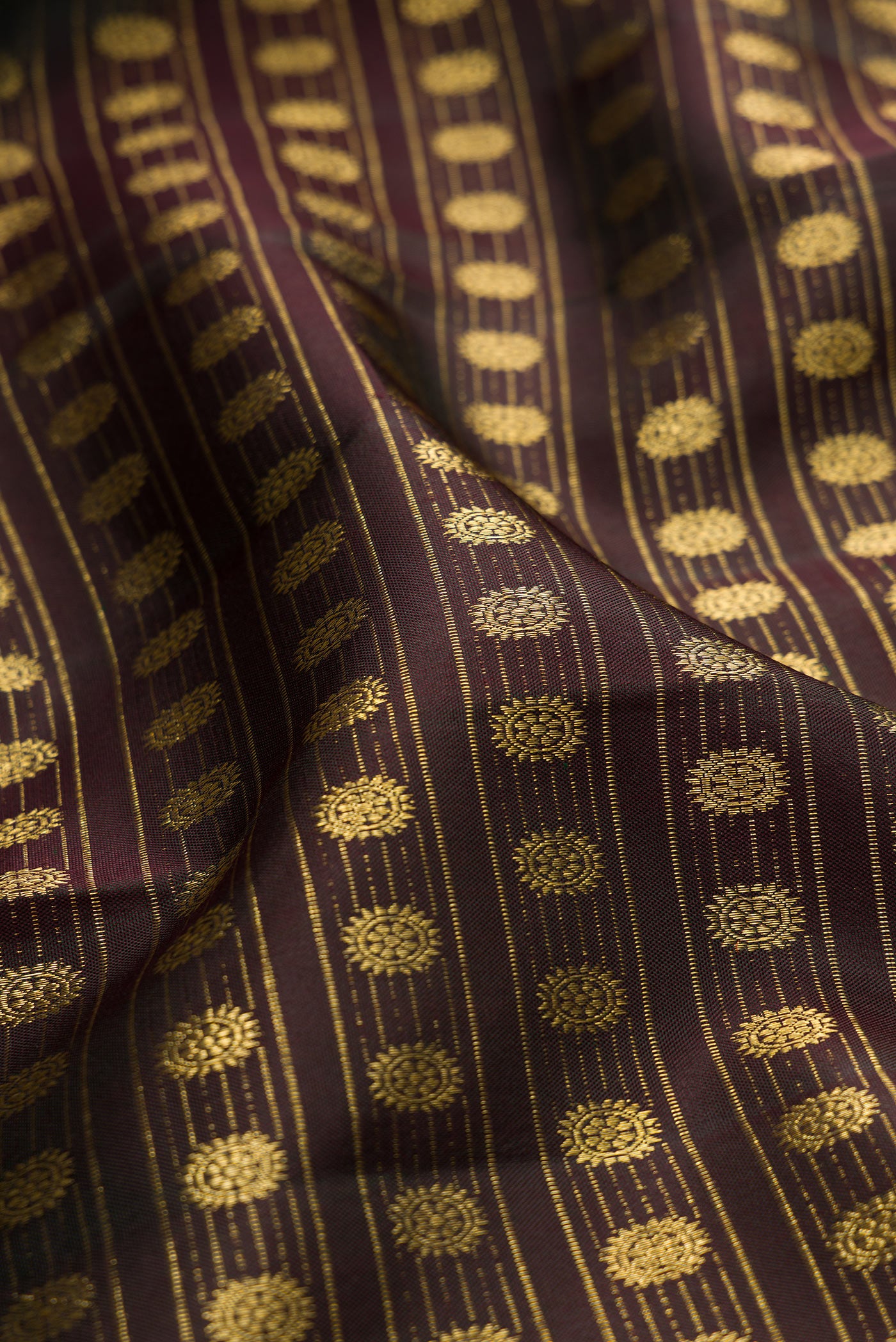 Close up of Coffee Brown Kanchipuram Silk Saree with Zari Brocade on the body and Fancy Border.  displaying folds