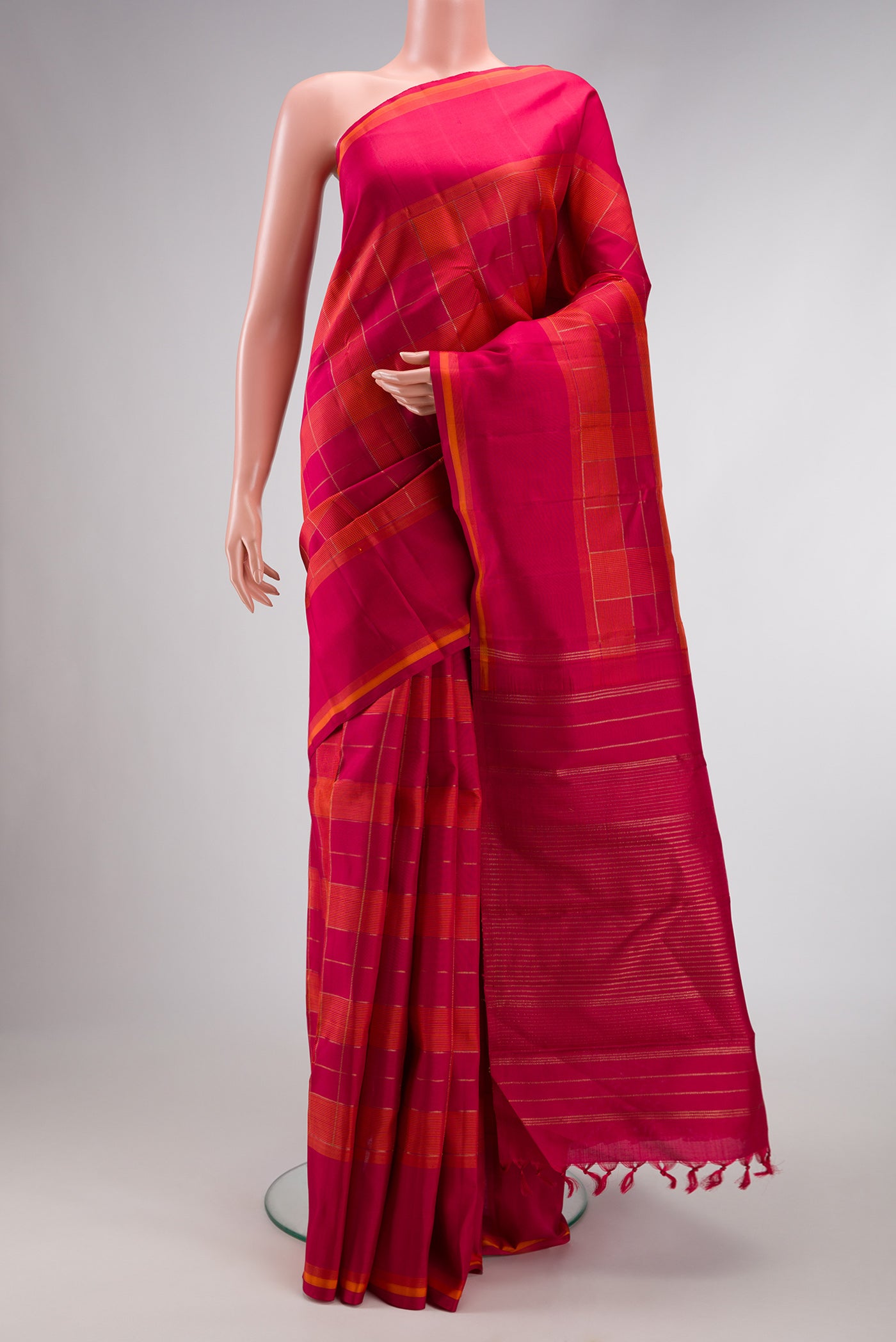 Pure Silk Pure Zari Dark Pink and Brick Orange Color Kanchipuram Saree with Checked design on the body and Thread Border.  displayed on a mannequin