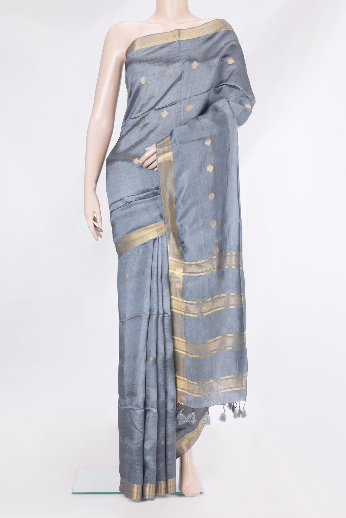 Grey Blended Tussar Silk Saree with Zari Butta on the body and Zari Border.  displayed on a mannequin