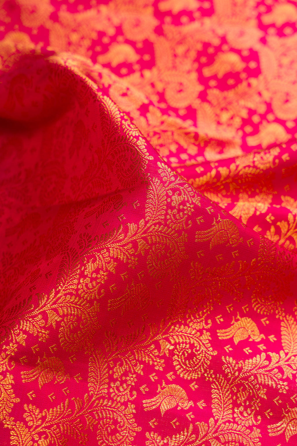 Close up of Pink Dual Tone Kanchipuram Silk Saree with Zari Brocade on the body and Zari Border.  displaying folds