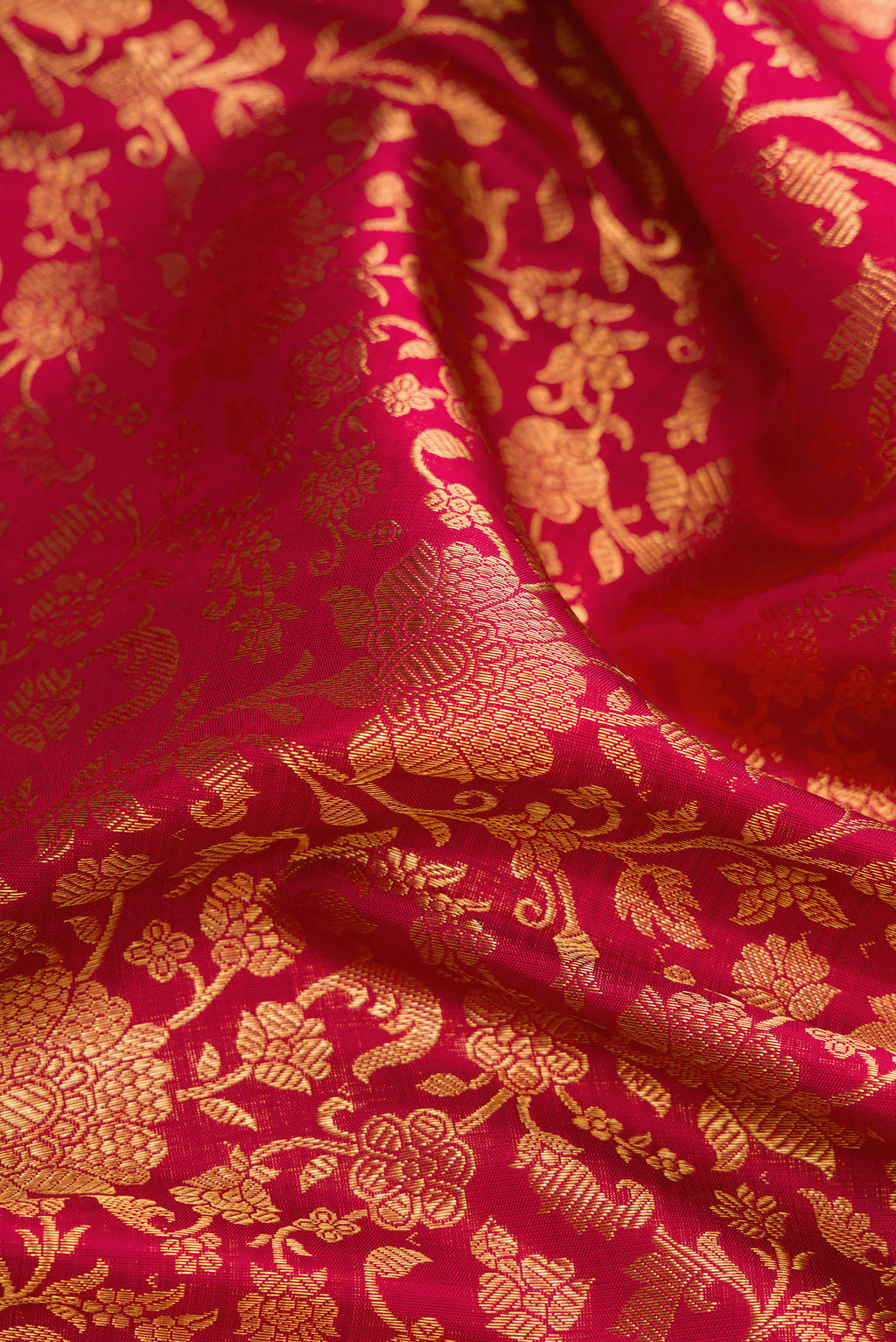 Close up of Maroon Dual Tone Kanchipuram Silk Saree with Zari Brocade on the body and Zari Border.  displaying folds