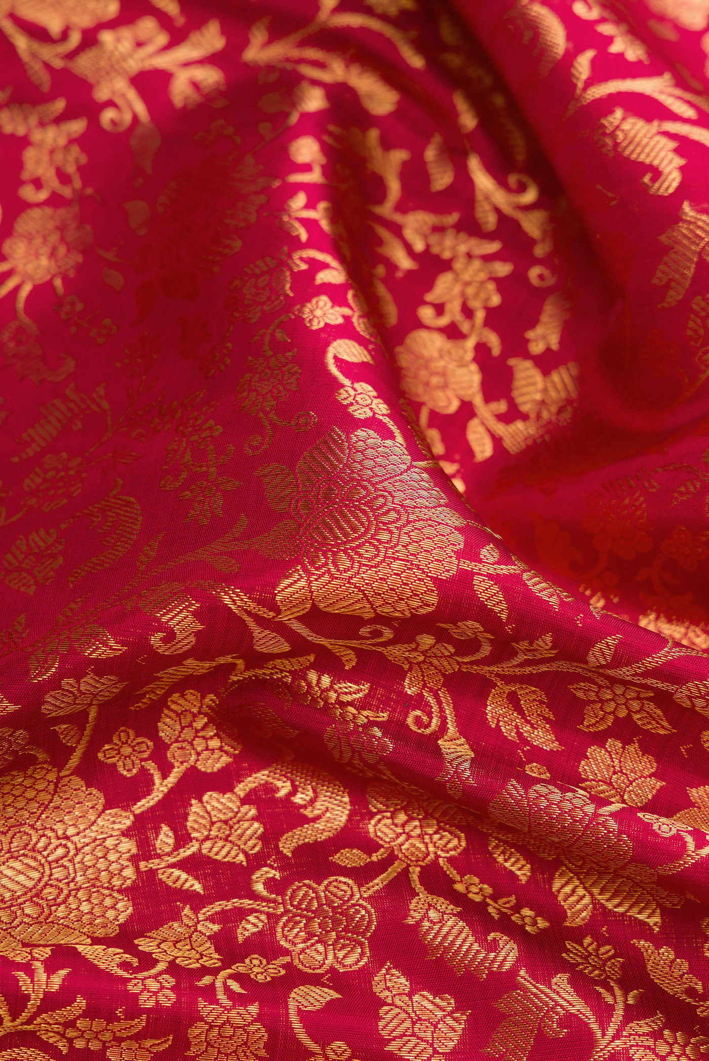 Close up of Maroon Dual Tone Kanchipuram Silk Saree with Zari Brocade on the body and Zari Border.  displaying folds