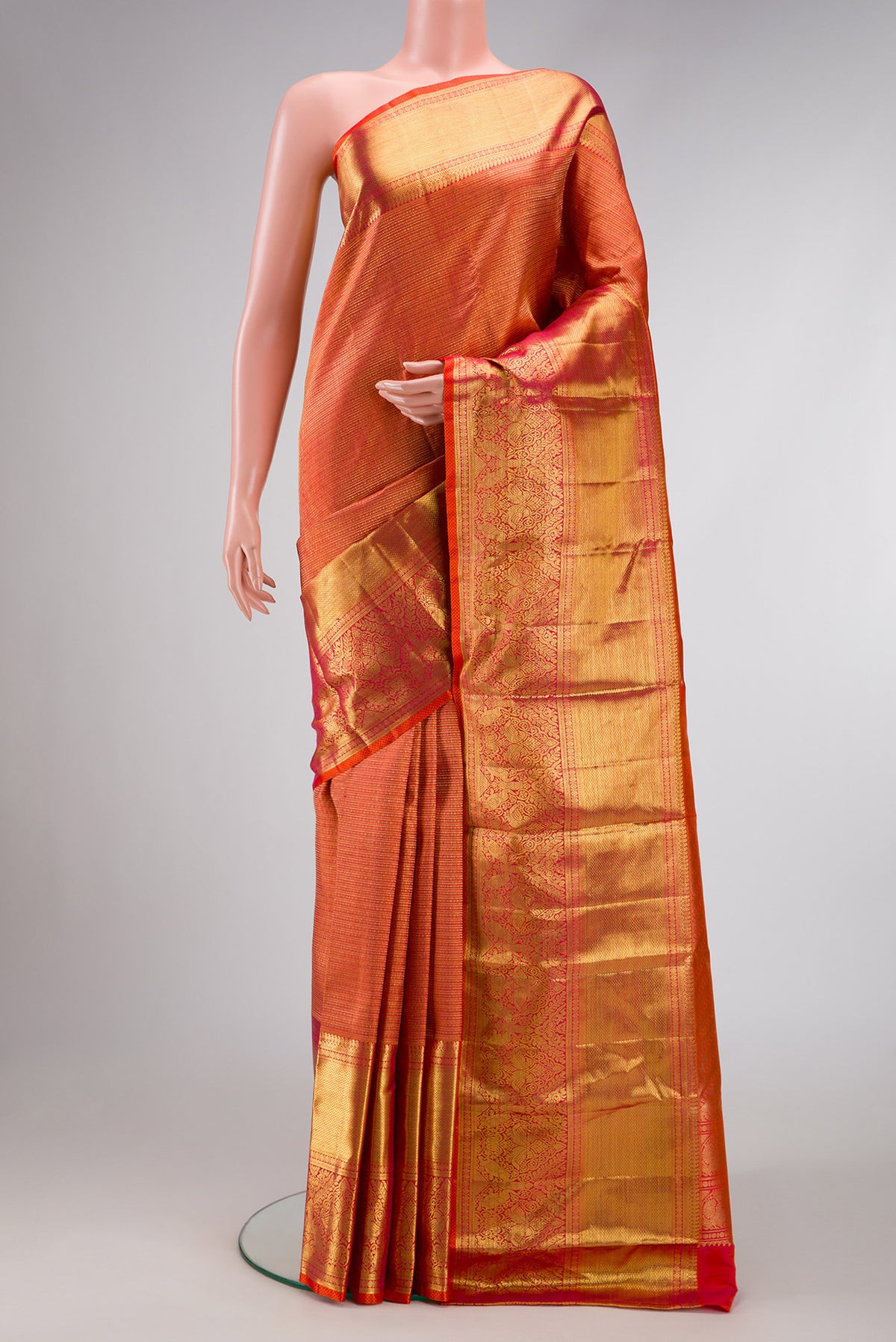 Coral Dual Tone Kanchipuram Silk Saree with Zari Brocade on the body and Zari Border.  displayed on a mannequin