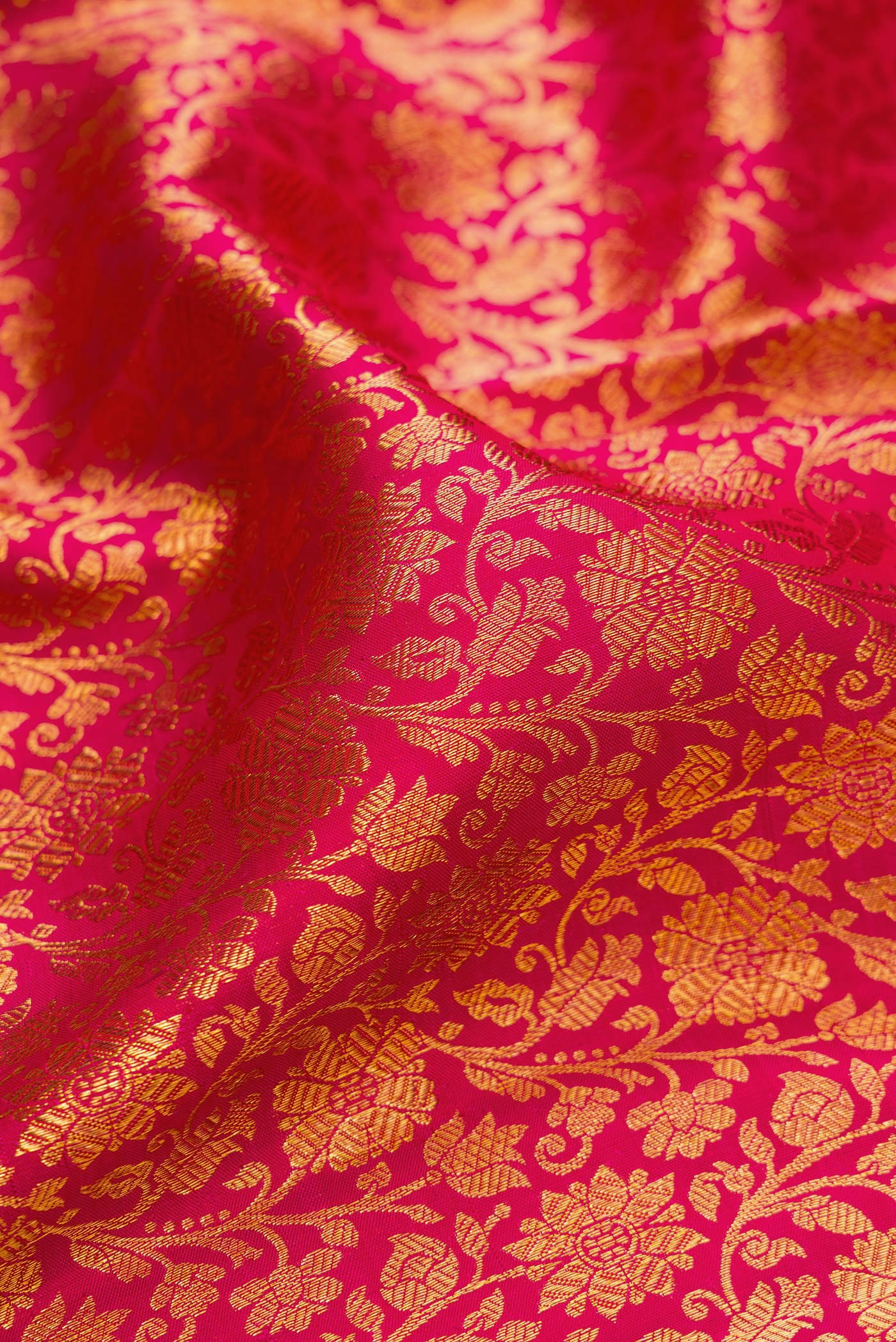 Close up of Dark Pink Kanchipuram Silk Saree with Zari Brocade on the body and Zari Border.  displaying folds