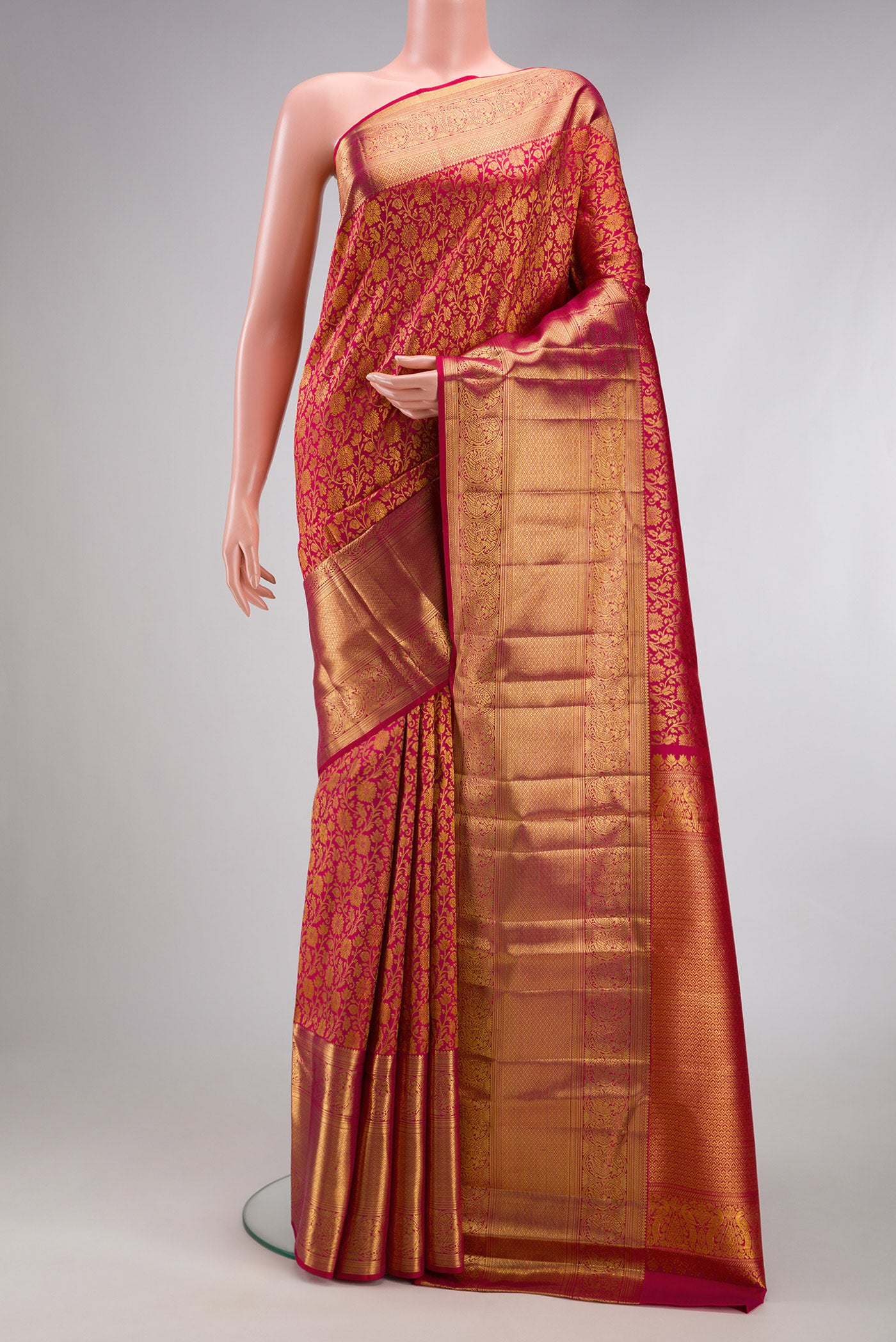 Dark Pink Kanchipuram Silk Saree with Zari Brocade on the body and Zari Border.  displayed on a mannequin