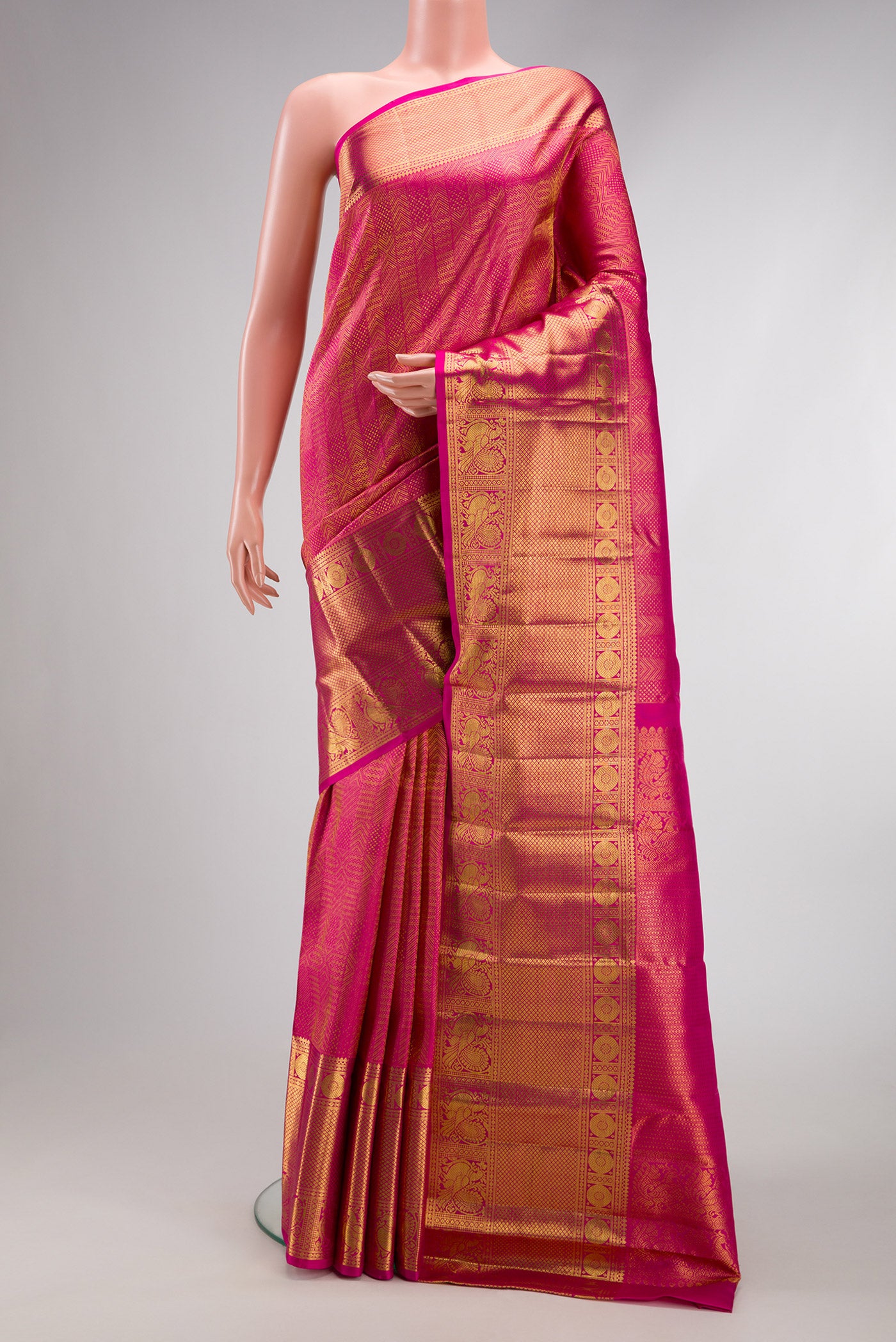 Dark Pink Kanchipuram Silk Saree with Zari Brocade on the body and Zari Border.  displayed on a mannequin