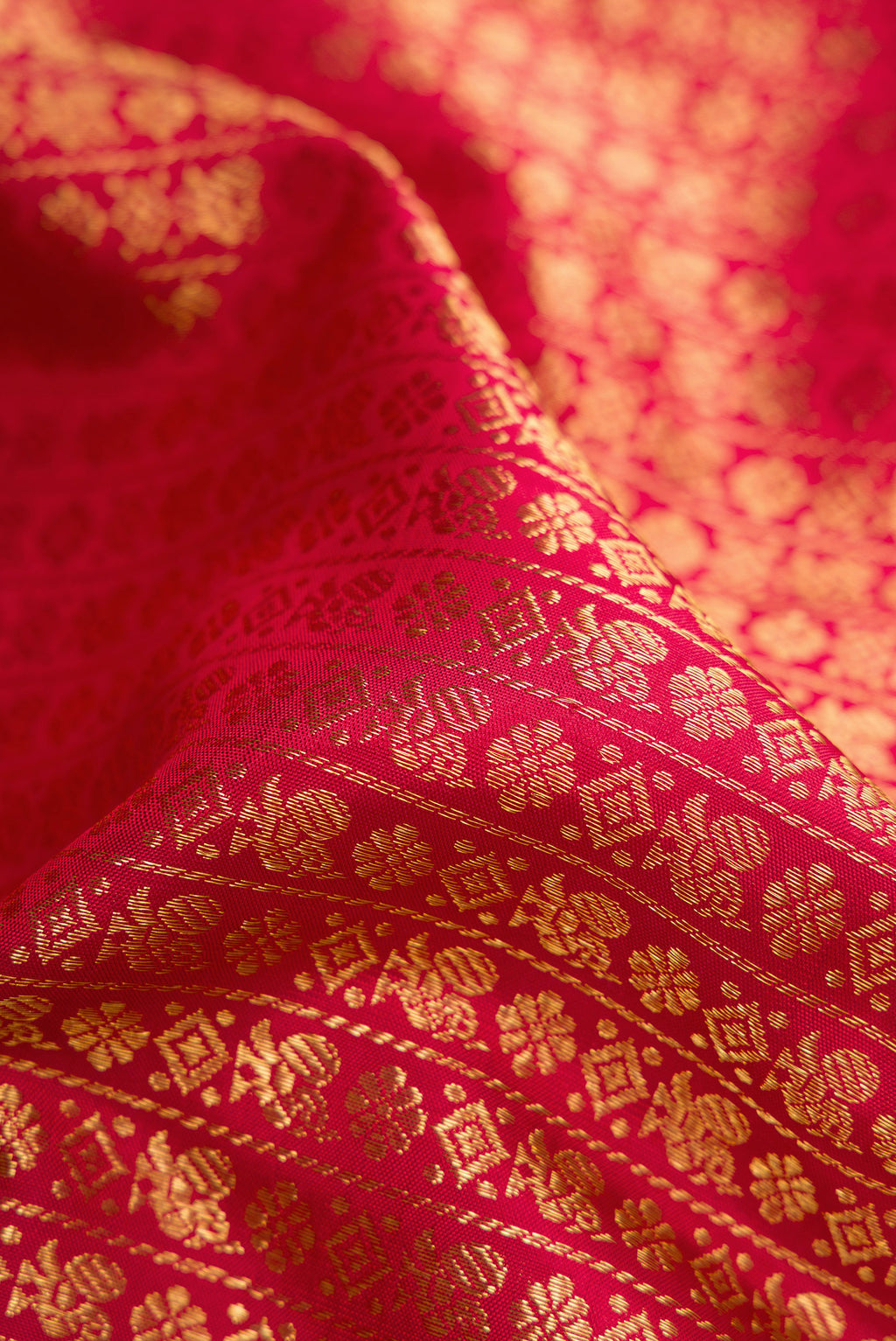Close up of Maroon Dual Tone Kanchipuram Silk Saree with Zari Brocade on the body and Zari Border.  displaying folds