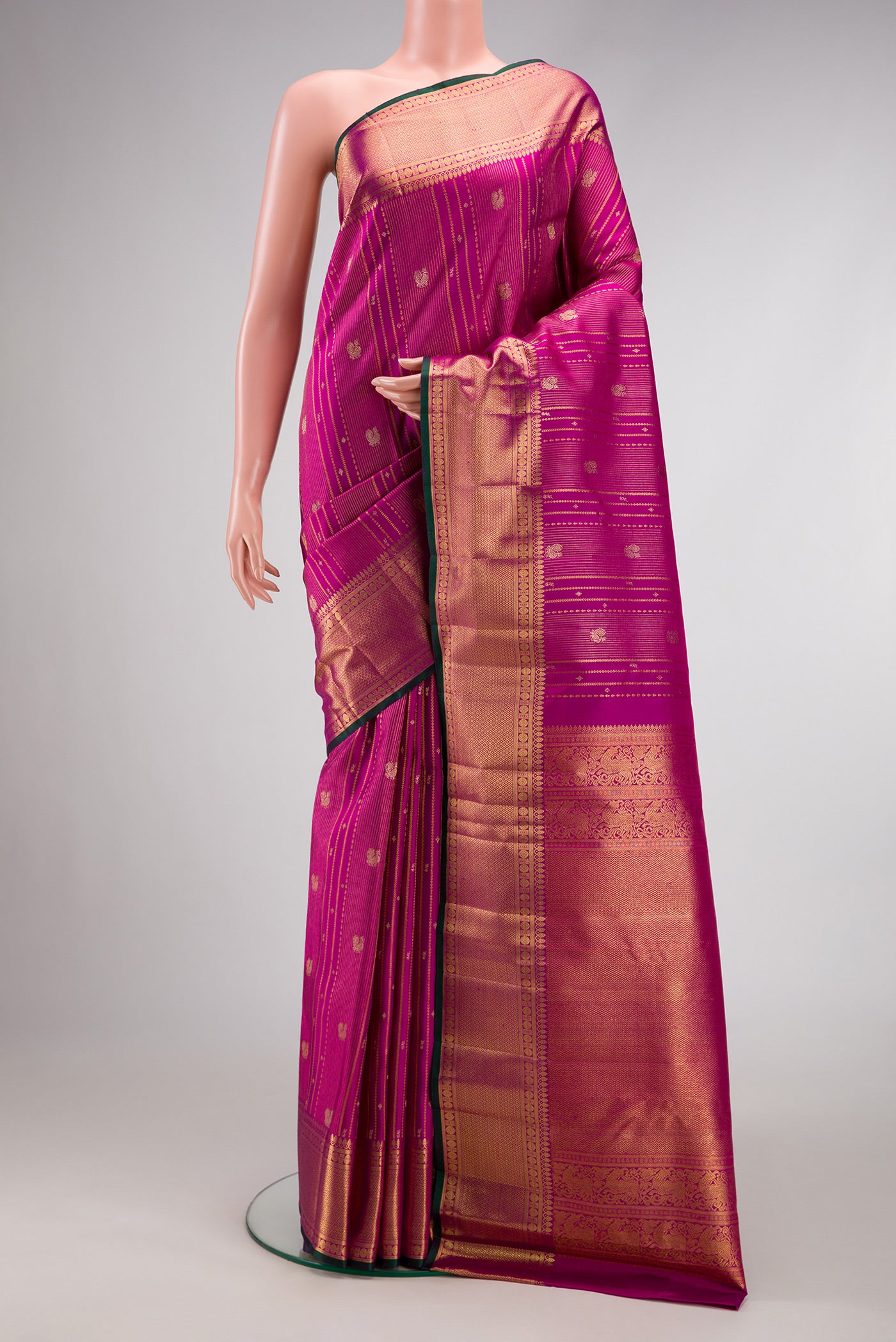 Magenta Dual Tone Kanchipuram Silk Saree with Zari Brocade on the body and Zari Border.  displayed on a mannequin