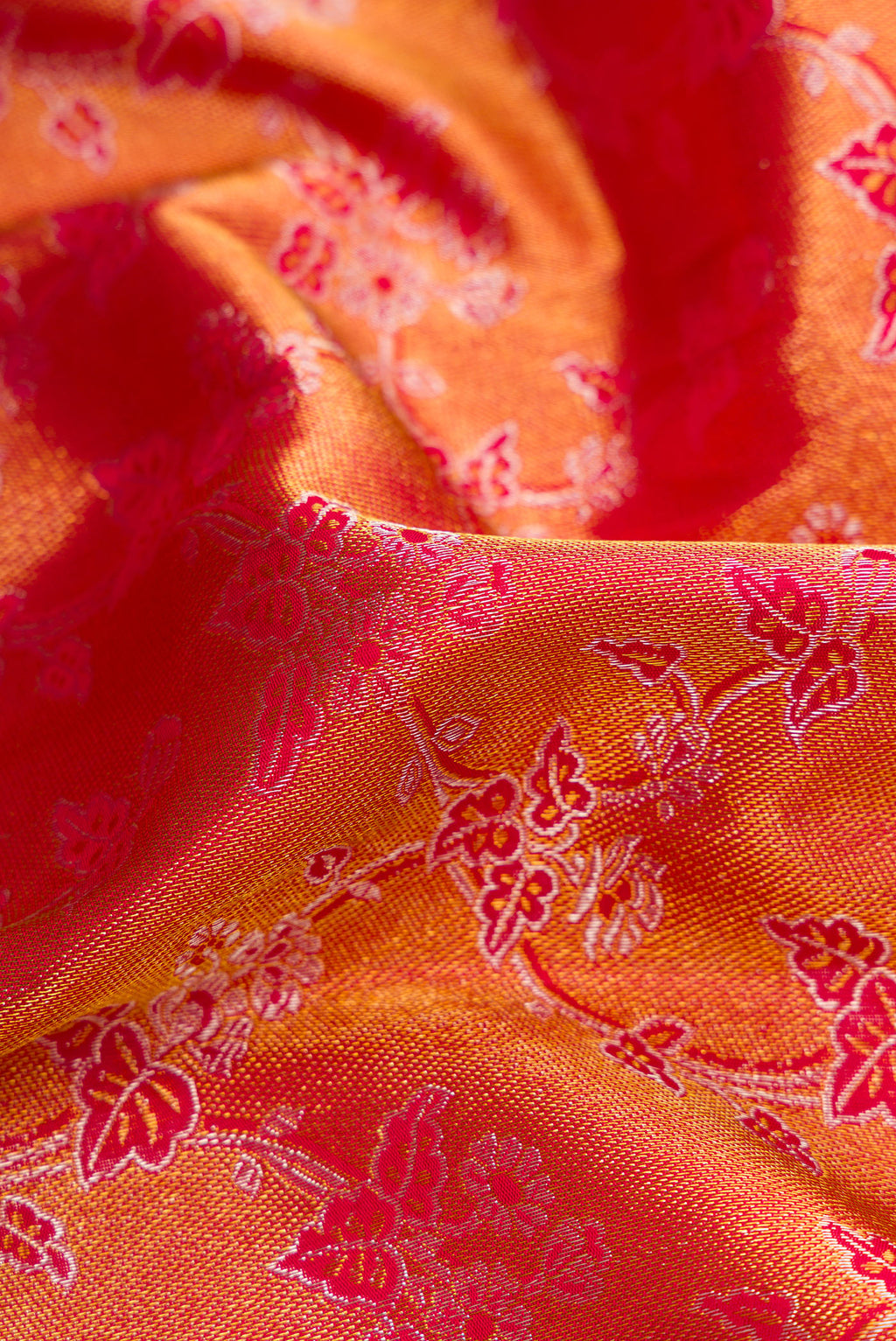 Close up of Red Dual Tone Kanchipuram Silk Saree with Zari Brocade on the body and Zari Border.  displaying folds