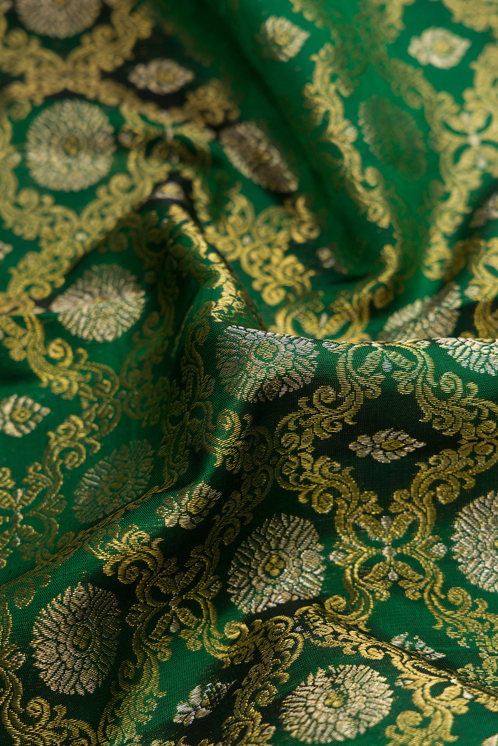 Close up of Green Dual Tone Kanchipuram Silk Saree with Zari Brocade on the body and Zari Border.  displaying folds