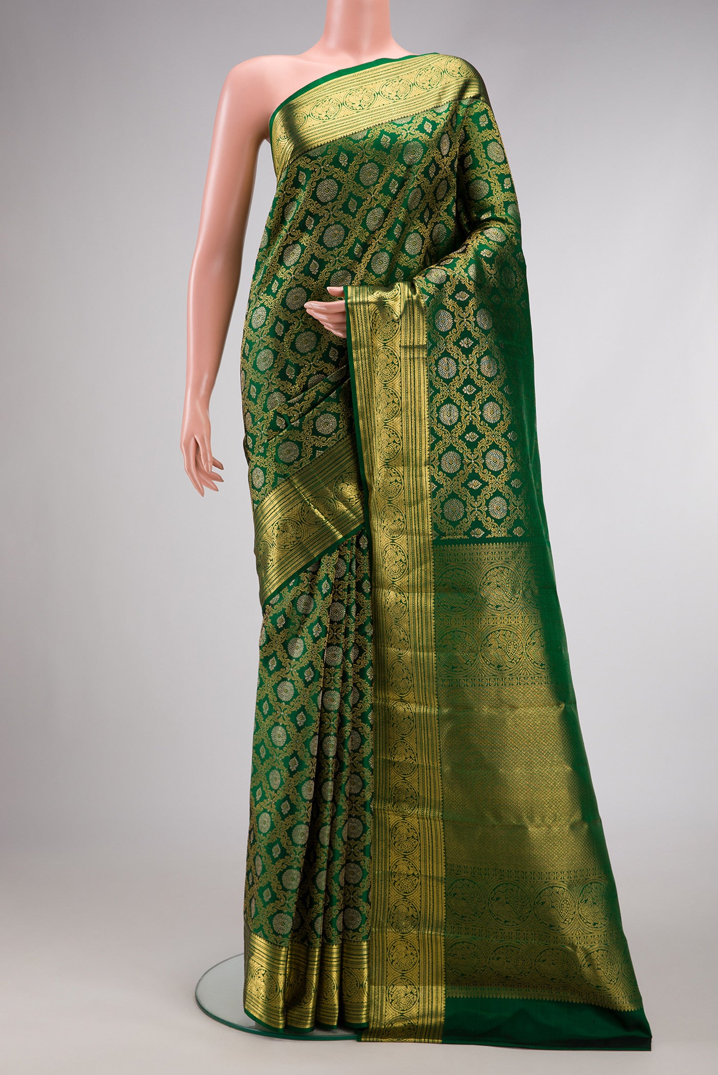 Green Dual Tone Kanchipuram Silk Saree with Zari Brocade on the body and Zari Border.  displayed on a mannequin
