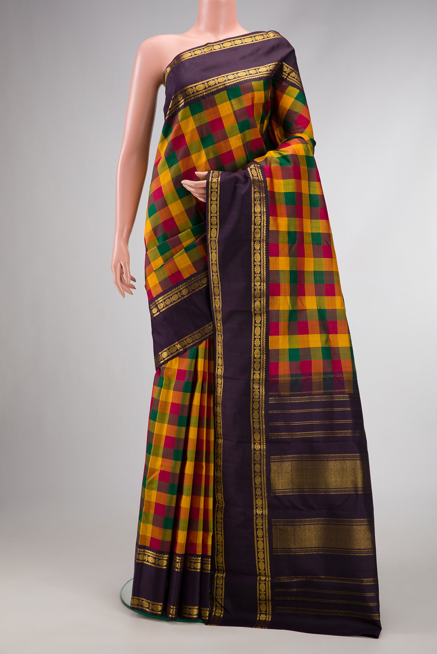 Pure Silk Pure Zari Green, Yelloe and Maroon Color Kanjivaram Saree with Checked design on the body and Zari Border.  displayed on a mannequin